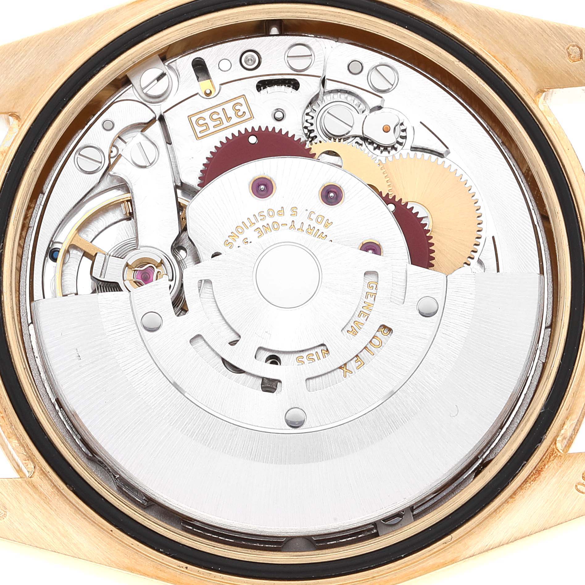 The image shows the movement of a Rolex President 118348 Men's Yellow Gold Green Dial model from a rear angle, highlighting gears and the rotor.