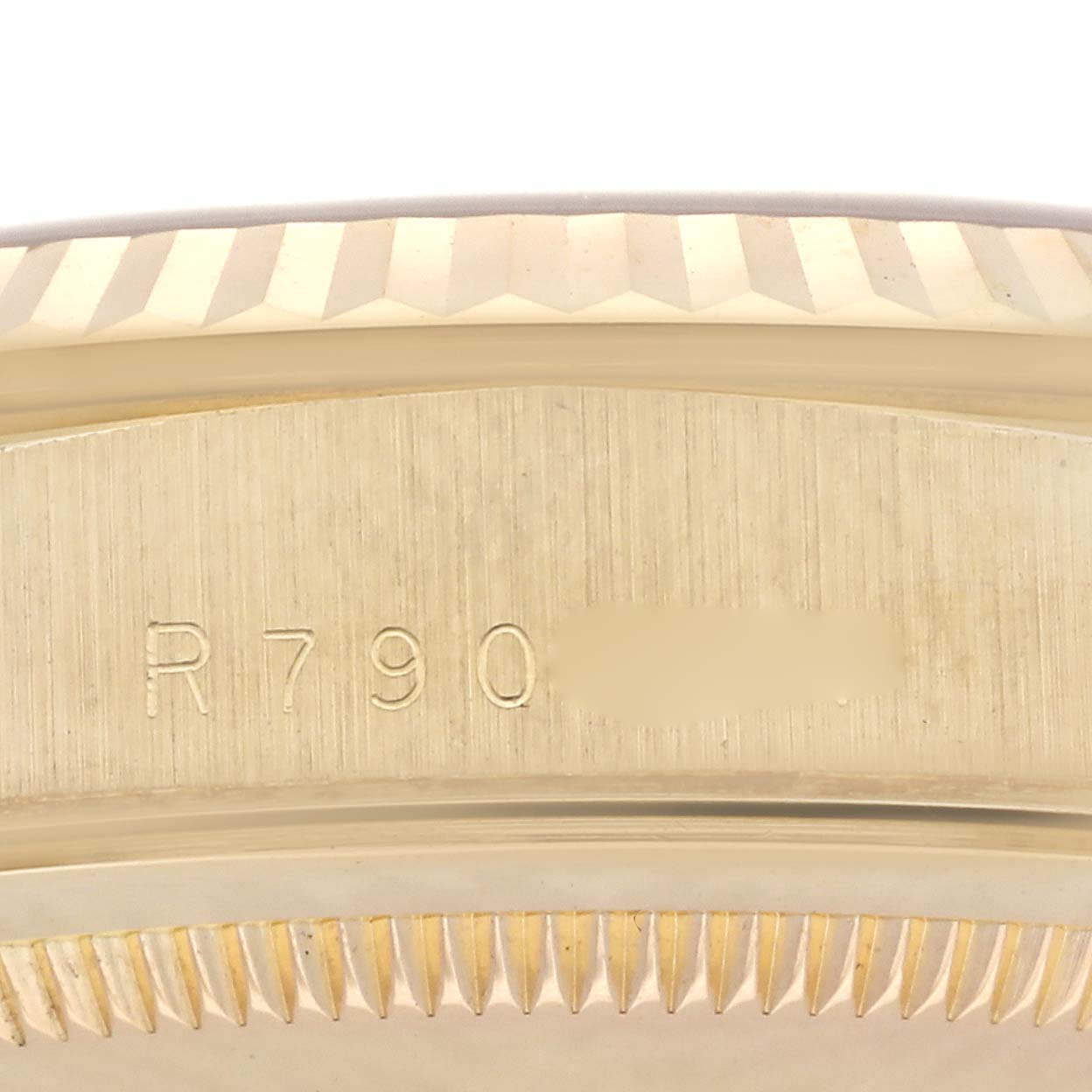 The image shows a close-up of the engraved edge and side of a Rolex President 18238 Men
s Yellow Gold Red Dial 18238 Men
s Yellow Gold Red Dial model watch.
