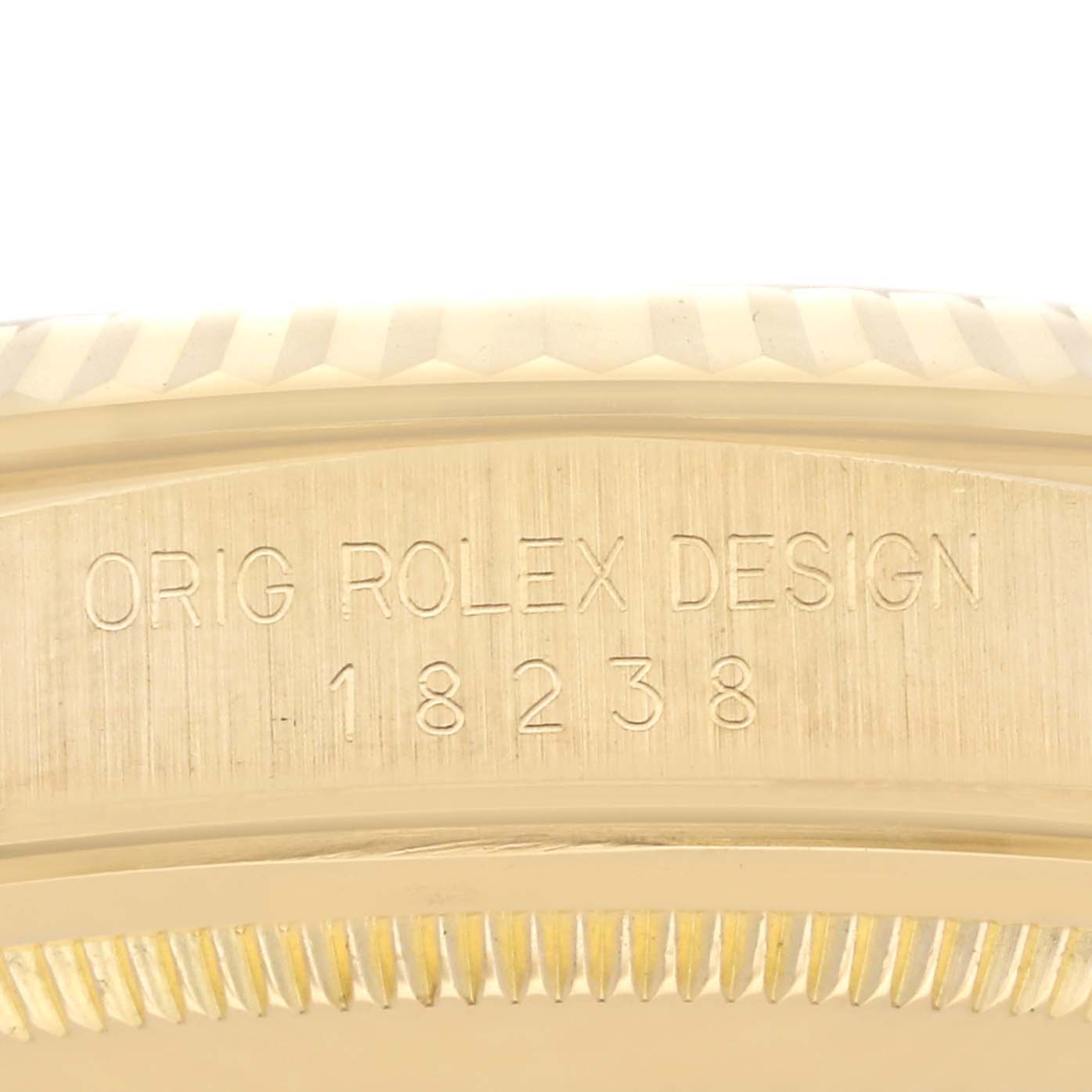 The image shows a close-up of the engraved case back edge of a Rolex President 18238 Men
s Yellow Gold Red Dial 18238 Men
s Yellow Gold Red Dial model.