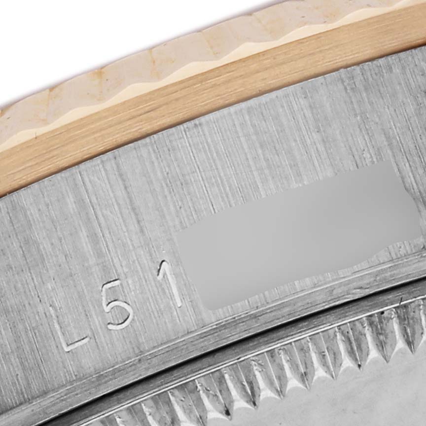 The image shows a close-up of the Rolex President 68279 Women
s White Gold Champagne Dial 68279 Women
s White Gold Champagne Dial model
s case edge and engraved serial number.