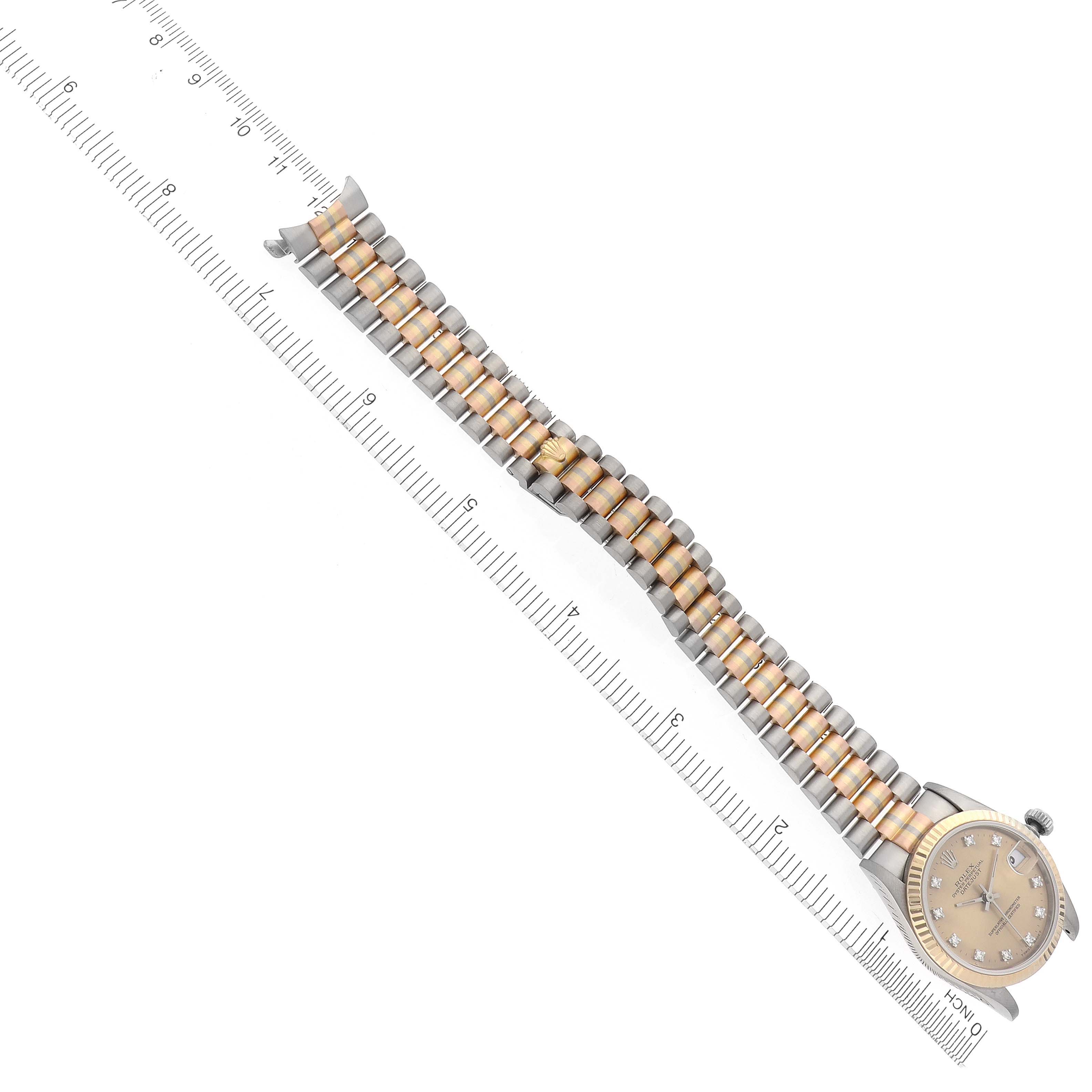 The Rolex President 68279 Women
s White Gold Champagne Dial 68279 Women
s White Gold Champagne Dial watch is shown from a top-down angle, highlighting its bracelet alongside a ruler for scale.