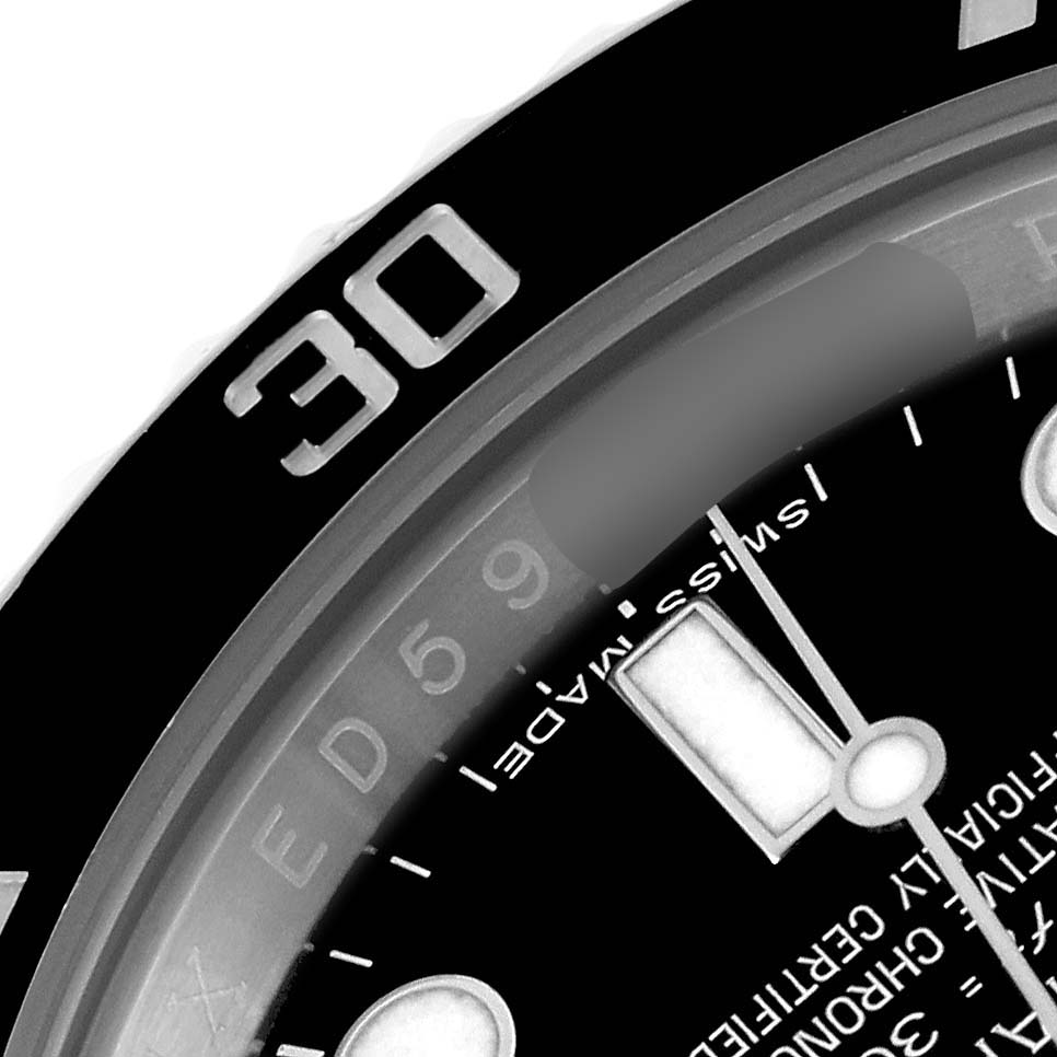The image shows a close-up of the bezel and dial of a Rolex Submariner 114060 Men
s Stainless Steel Black Dial 114060 Men
s Stainless Steel Black Dial watch, highlighting the 30-minute marker and part of the dial.