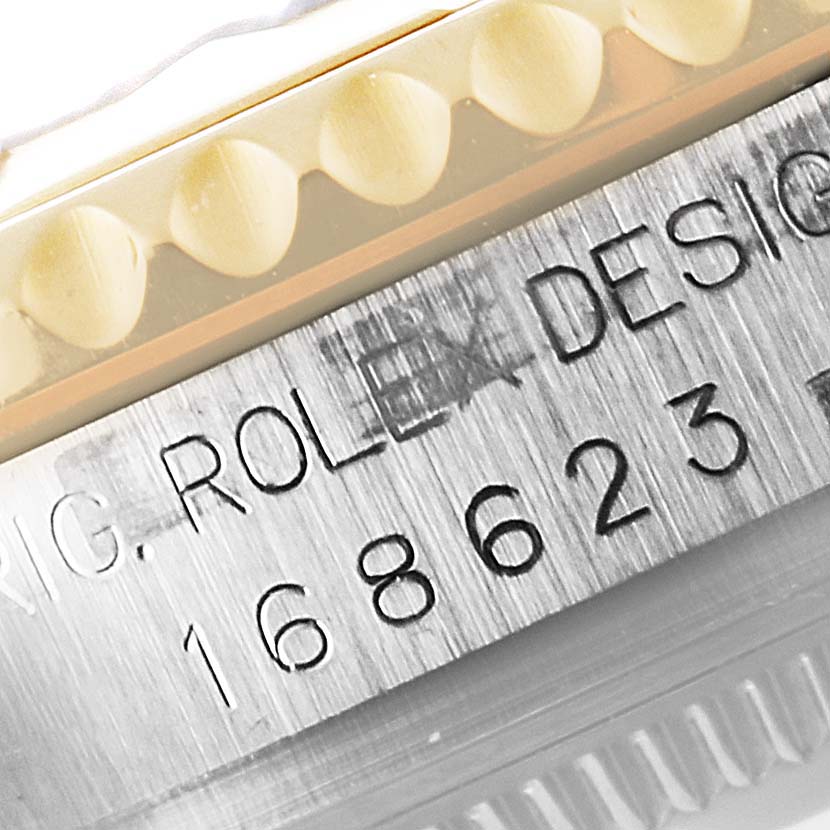 The image shows a close-up of the case side and serial number engraving on a Rolex Yacht-Master 168623 Women's Steel and Gold (two tone) Blue Dial 168623 Women's Steel and Gold (two tone) Blue Dial watch.