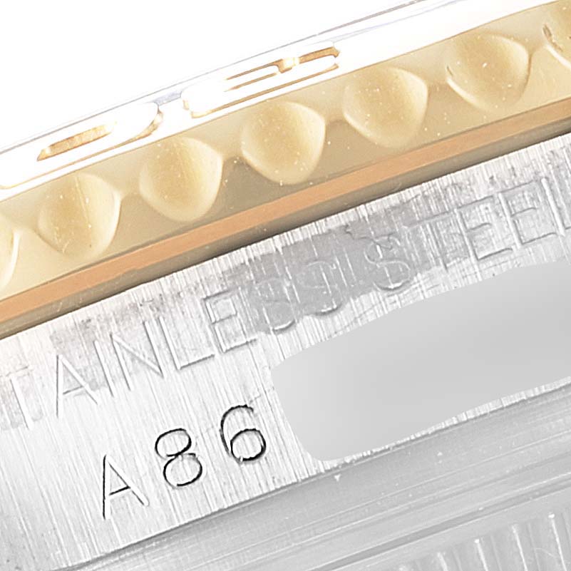 Close-up view of the Rolex Yacht-Master 168623 Women's Steel and Gold (two tone) Blue Dial 168623 Women's Steel and Gold (two tone) Blue Dial model's bezel and part of the stainless steel case with engraved markings.