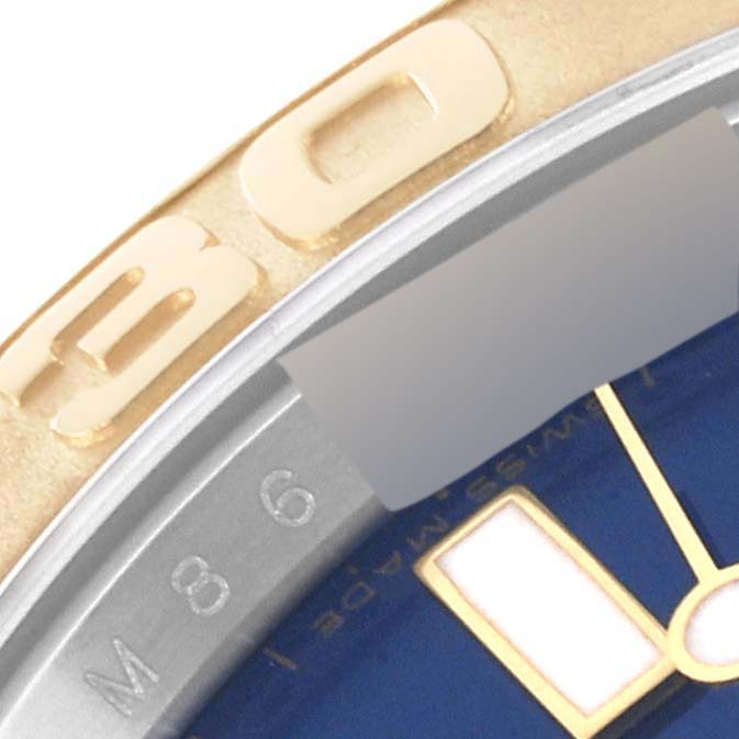 The image shows a close-up of the bezel and part of the blue dial of a Rolex Yacht-Master 16623 Men's Steel and Gold (two tone) Blue Dial 16623 Men's Steel and Gold (two tone) Blue Dial watch.