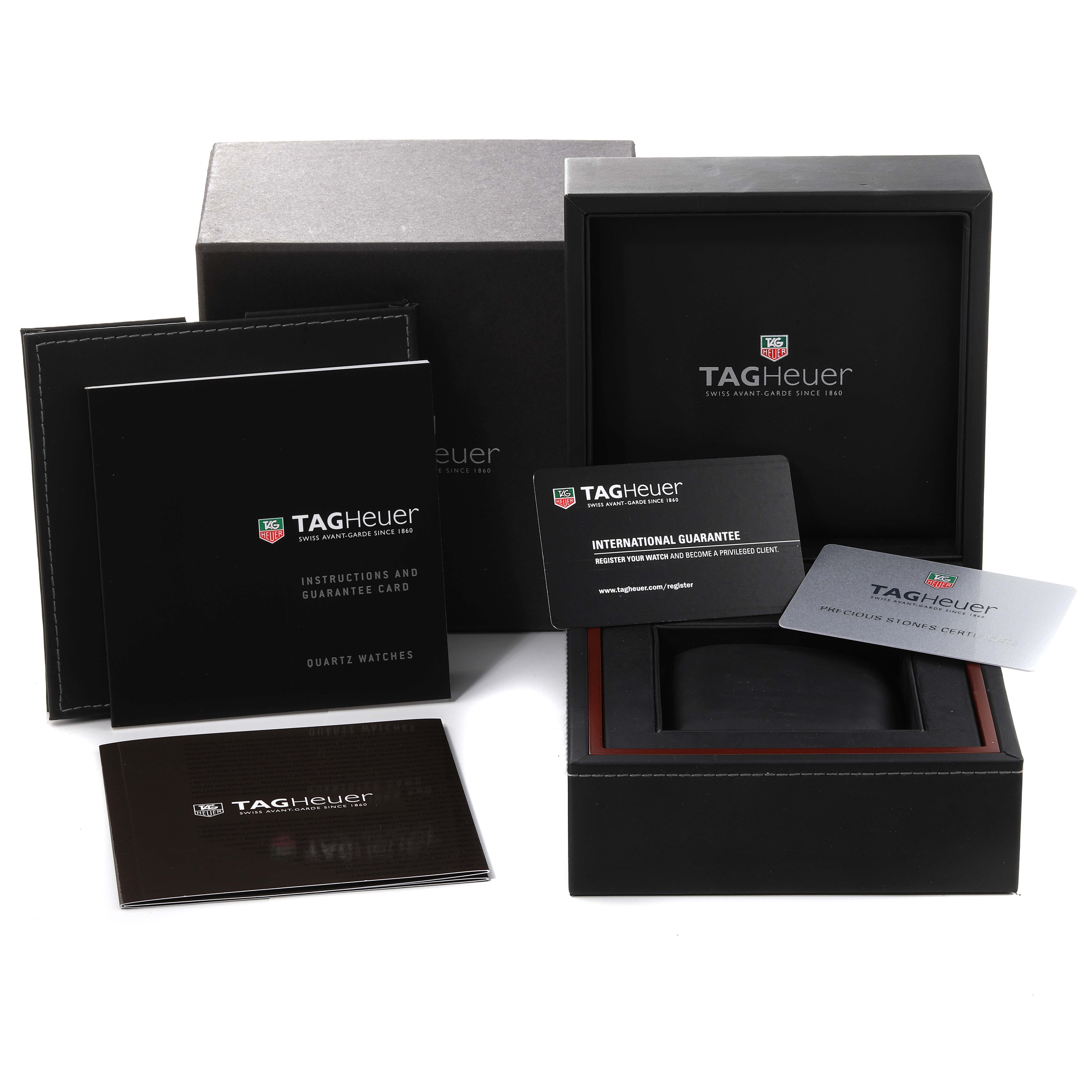 The image shows the packaging, warranty cards, and instruction manuals for an Aquaracer by Tag Heuer.