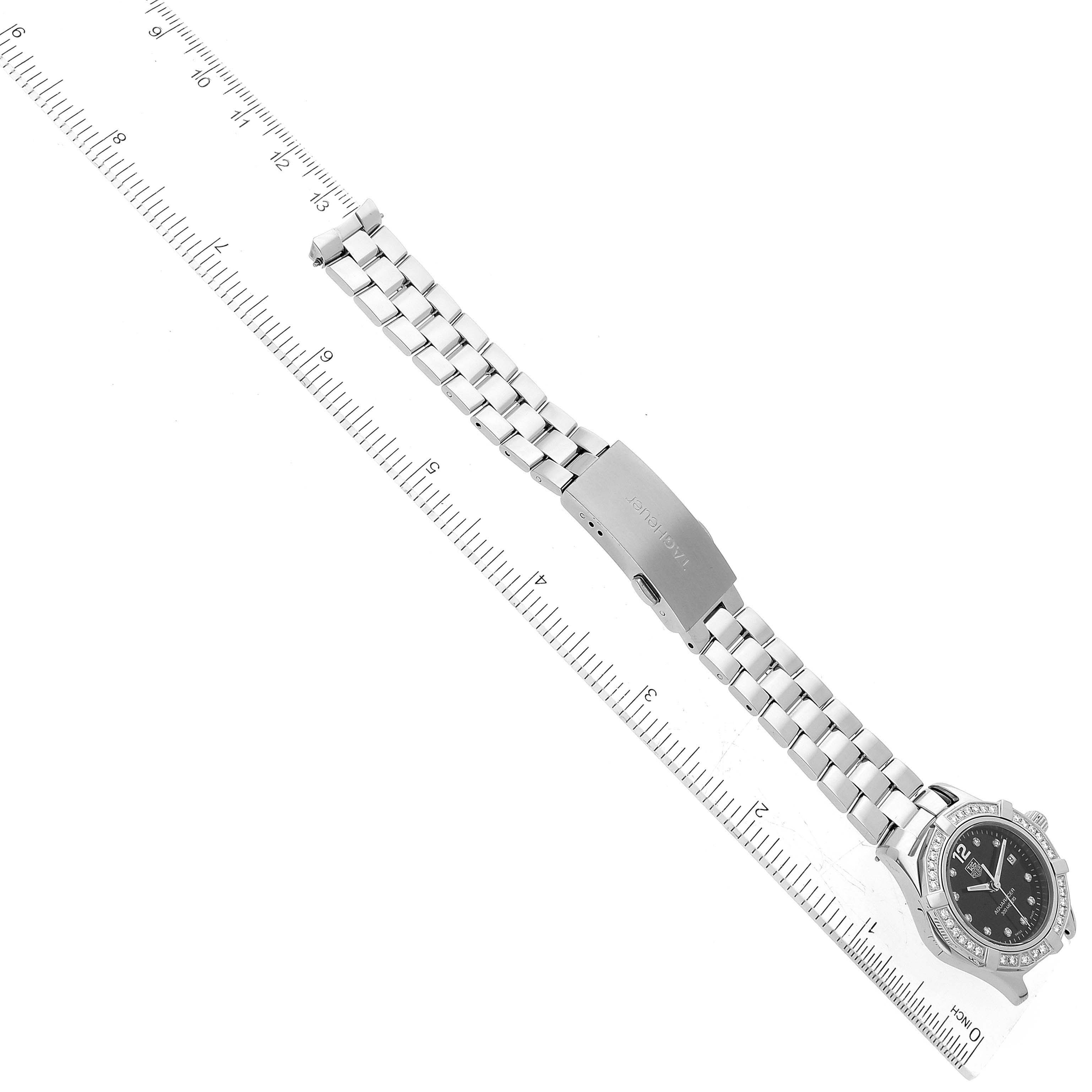 The Tag Heuer Aquaracer WAF141D Women's Stainless Steel Black Dial WAF141D Women's Stainless Steel Black Dial watch is shown from above with its band extended and a measurement ruler beside it.