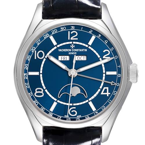 The Vacheron Constantin Fiftysix watch is shown from a front angle, highlighting the blue dial, hands, and calendar features.