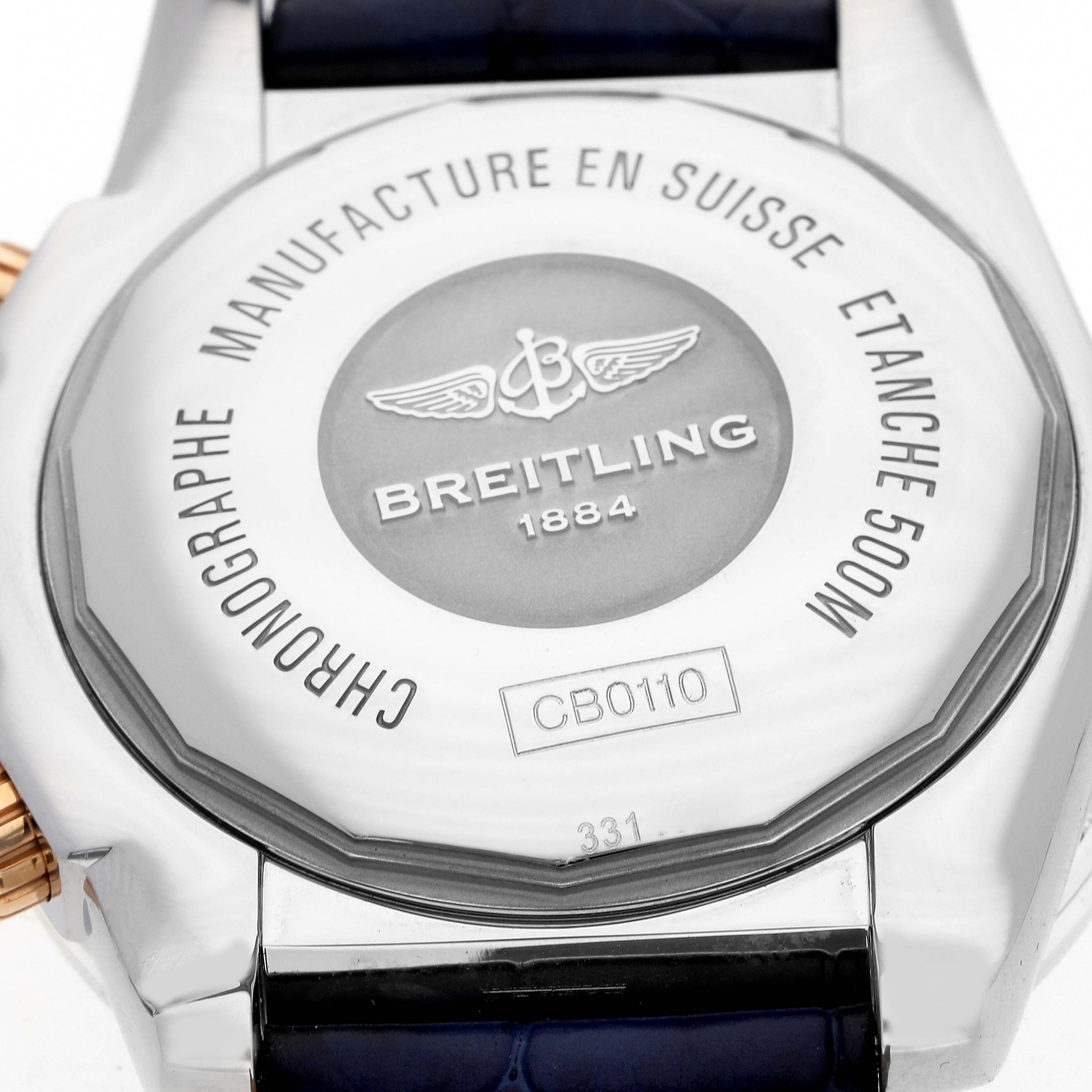 The image shows the back case of a Breitling Chronomat CB0110 Men's Steel and Gold (two tone) Blue Dial watch, highlighting its branding and model details.