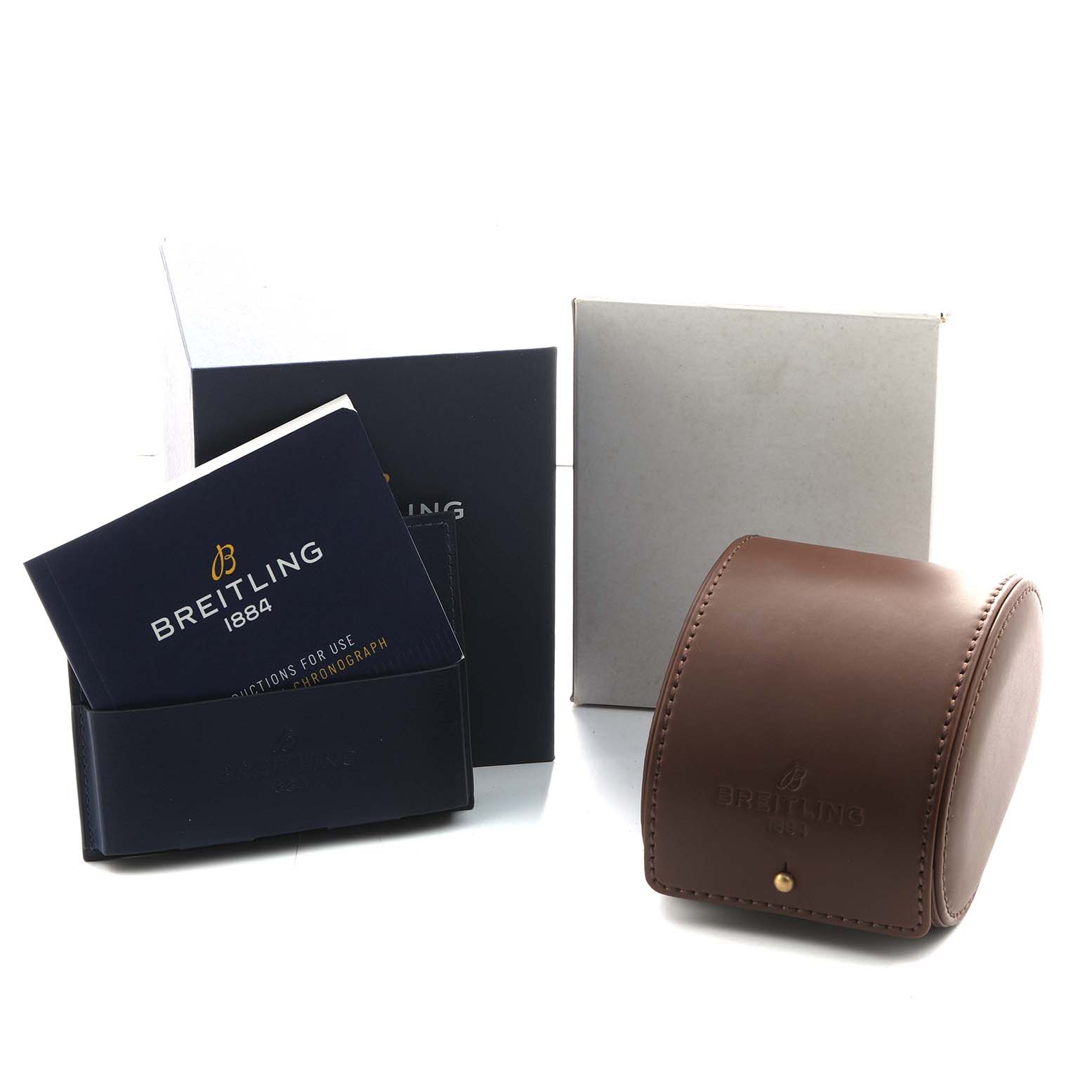 The image shows Breitling Chronomat CB0110 Men's Steel and Gold (two tone) Blue Dial watch accessories, including a leather case, instruction booklet, and outer boxes, from a front angle.