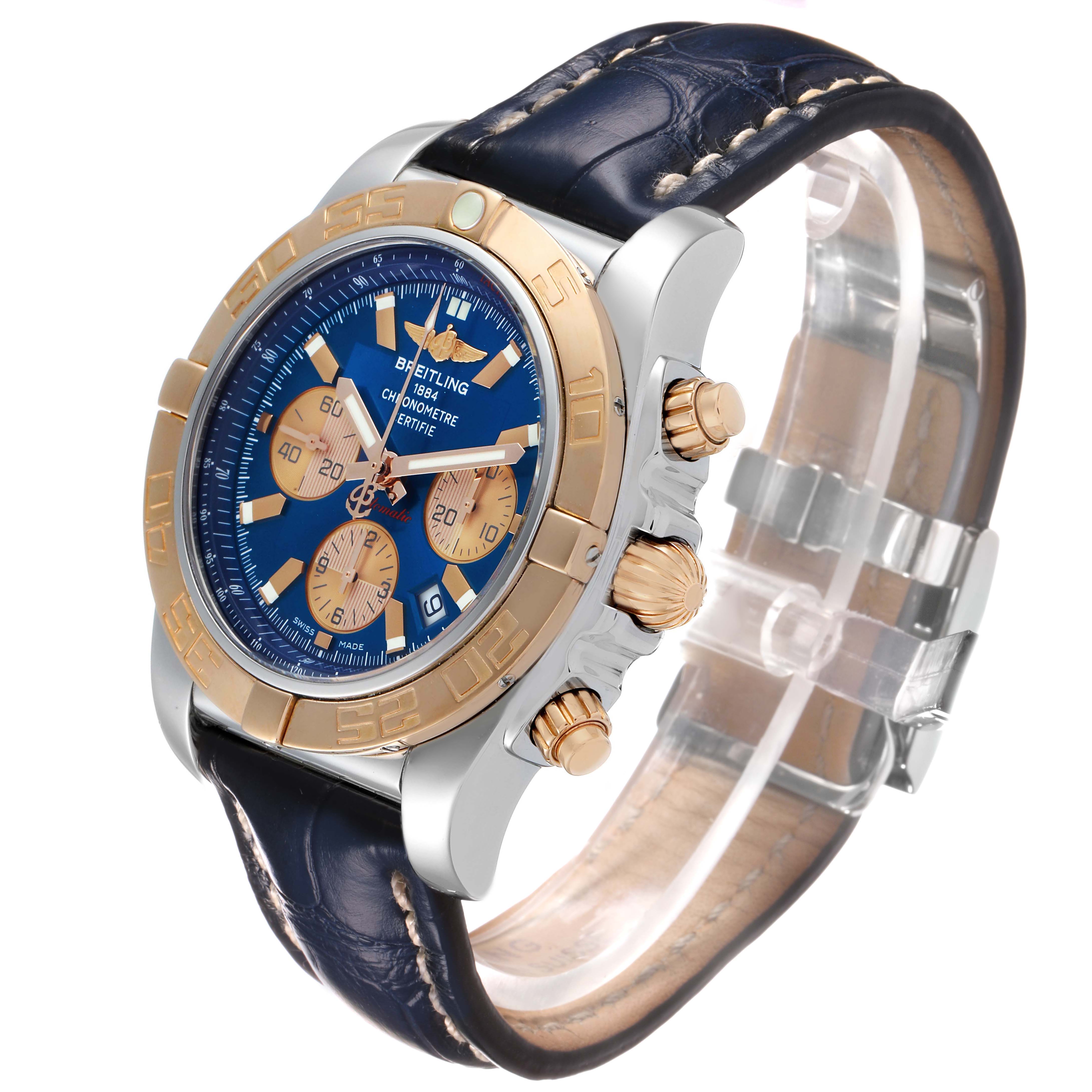 The Breitling Chronomat CB0110 Men's Steel and Gold (two tone) Blue Dial watch is shown at an angled side view, highlighting the bezel, dial, pushers, and leather strap.
