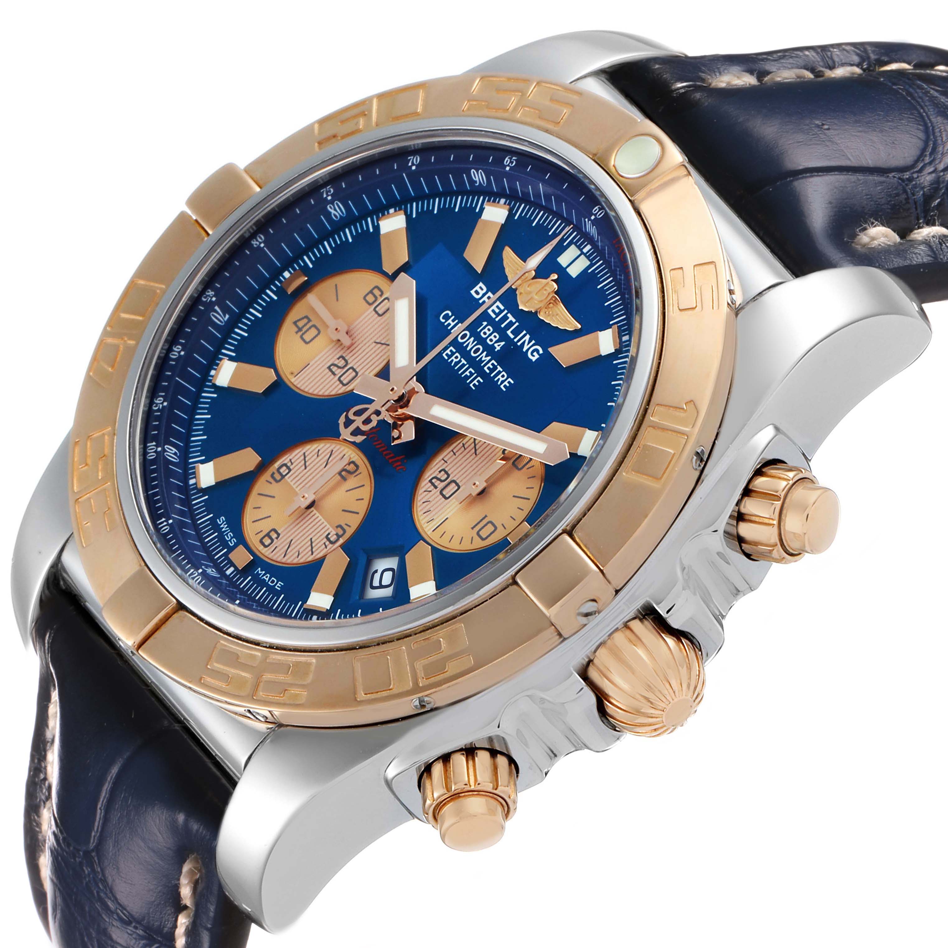 The Breitling Chronomat CB0110 Men's Steel and Gold (two tone) Blue Dial watch is shown at an angle, displaying the face, bezel, crown, pushers, and strap.