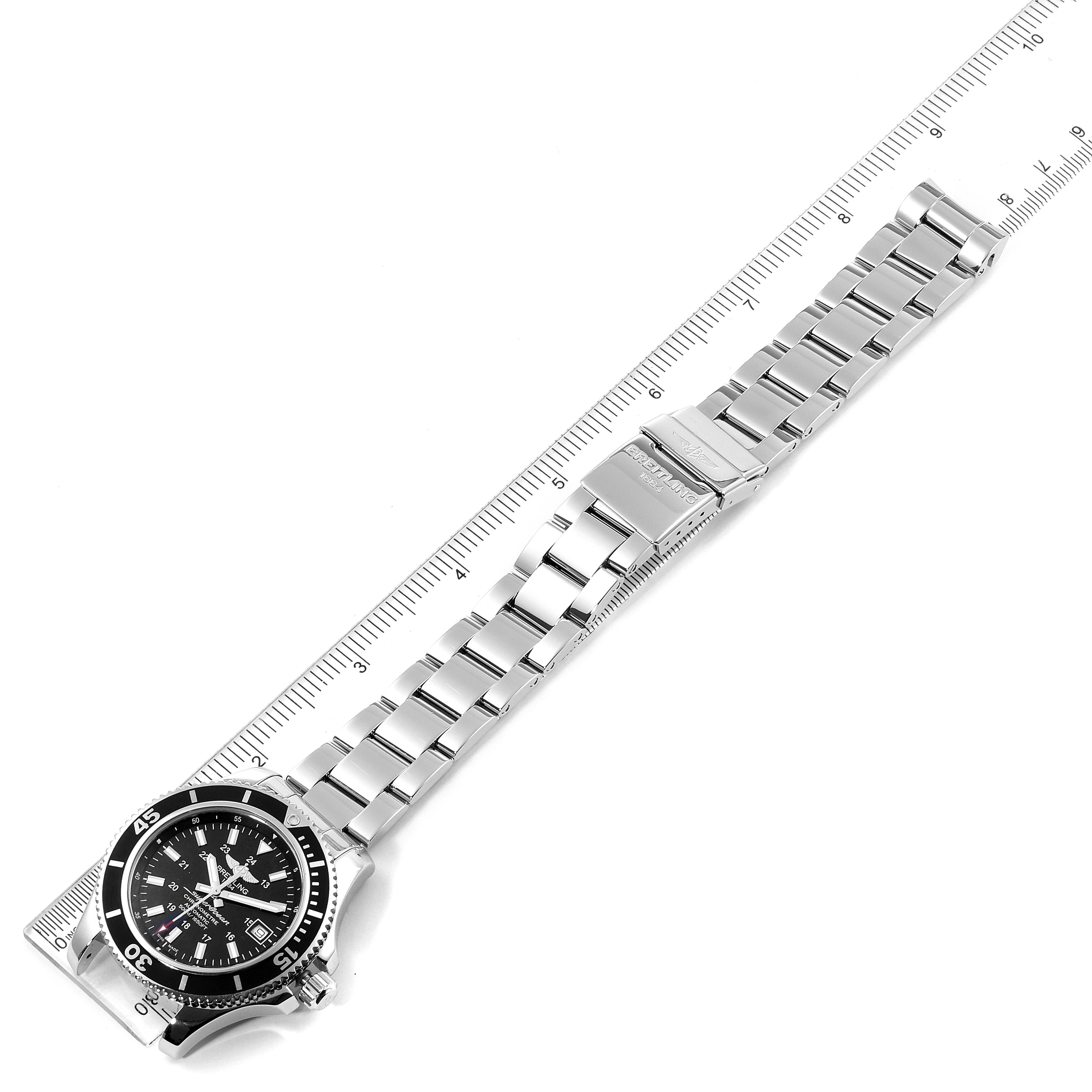 This image shows a top-down angle of the Breitling Superocean A17365 Men's Stainless Steel Black Dial A17365 Men's Stainless Steel Black Dial watch, fully displaying the bracelet and clasp, with a ruler measuring its length.