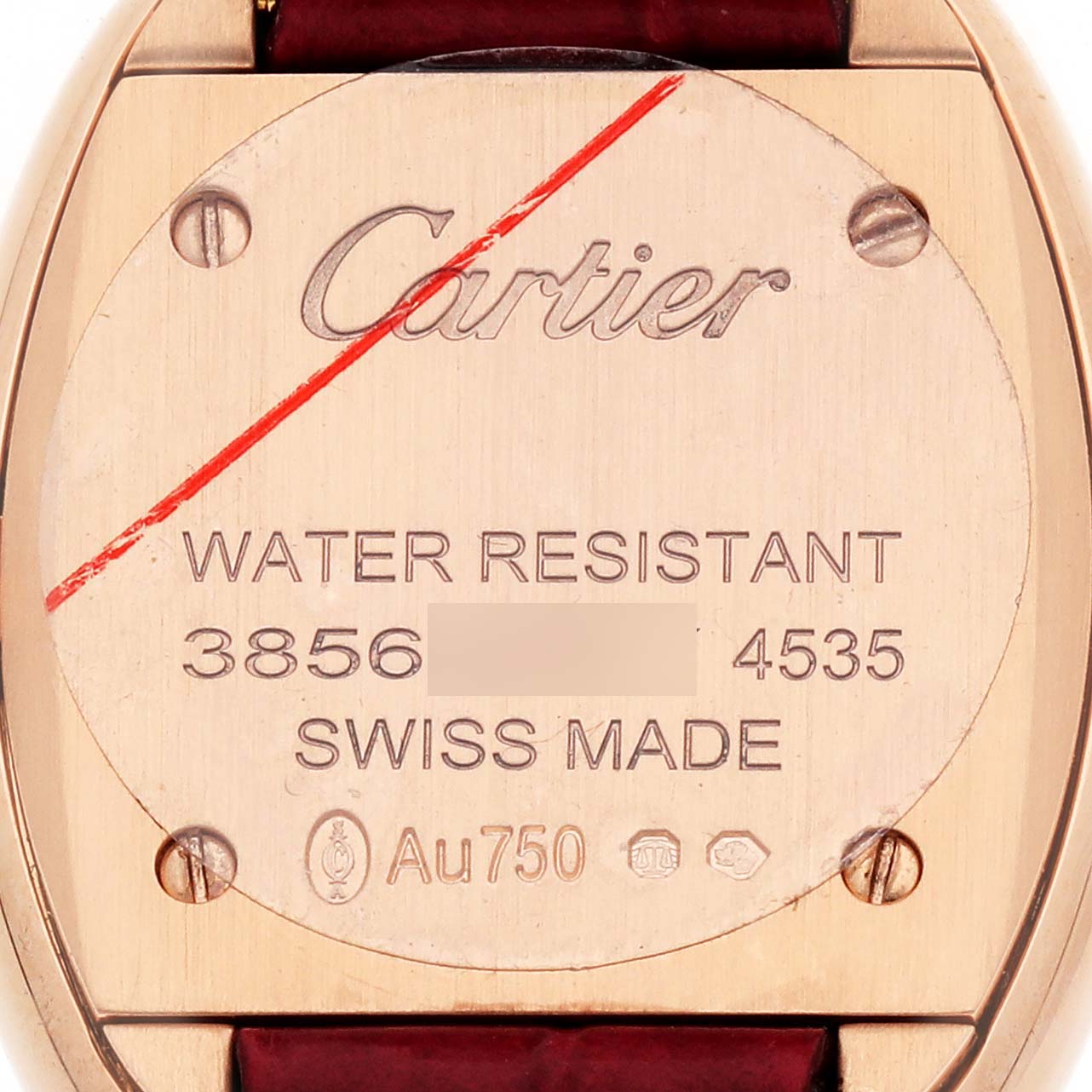 The image shows the back of a Cartier Baignoire WJBA0031 Women's Rose Gold Silver Dial watch with engravings and hallmarks.