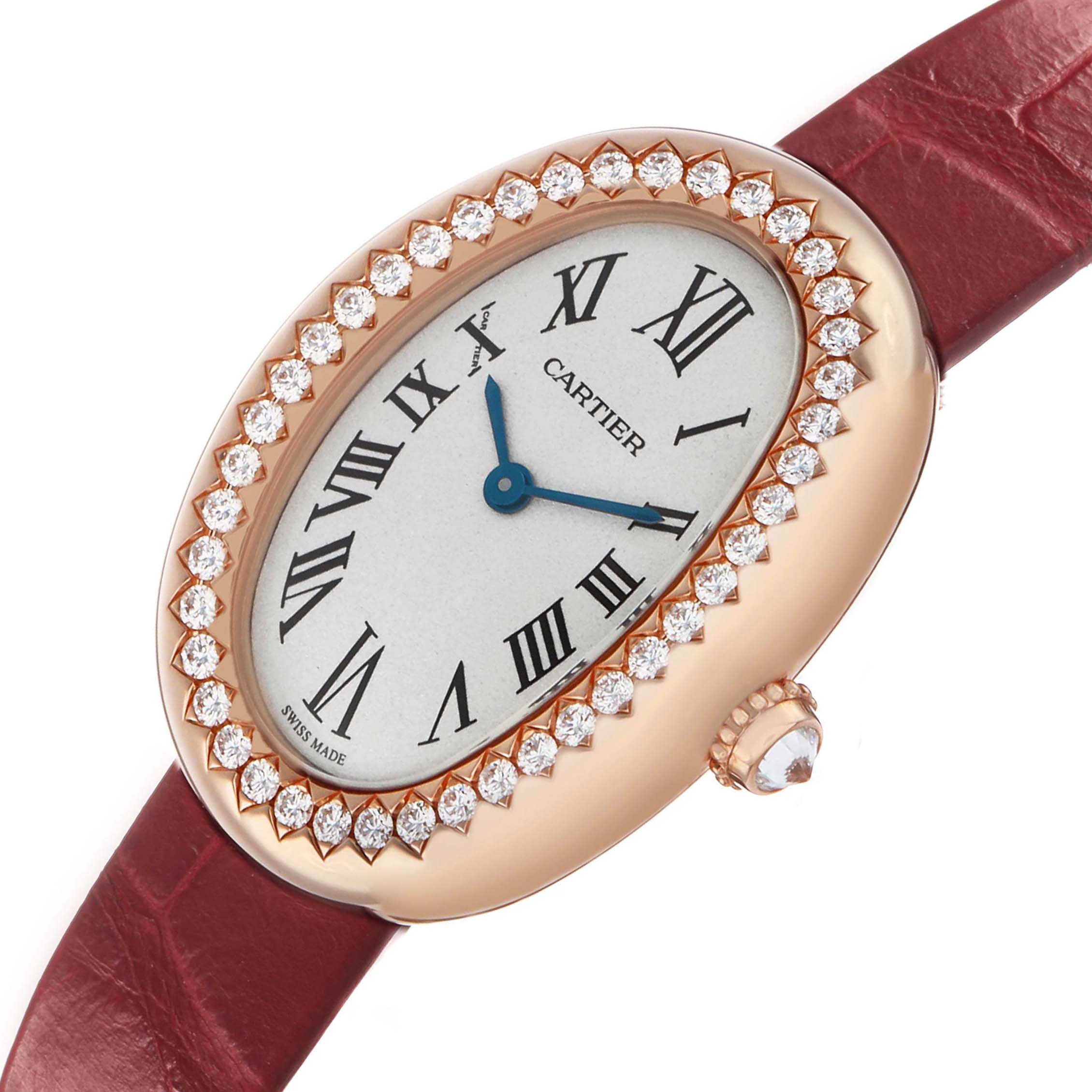 The Cartier Baignoire WJBA0031 Women's Rose Gold Silver Dial watch is shown at a slight angle featuring its diamond-studded bezel, oval dial, blue hands, and red strap.