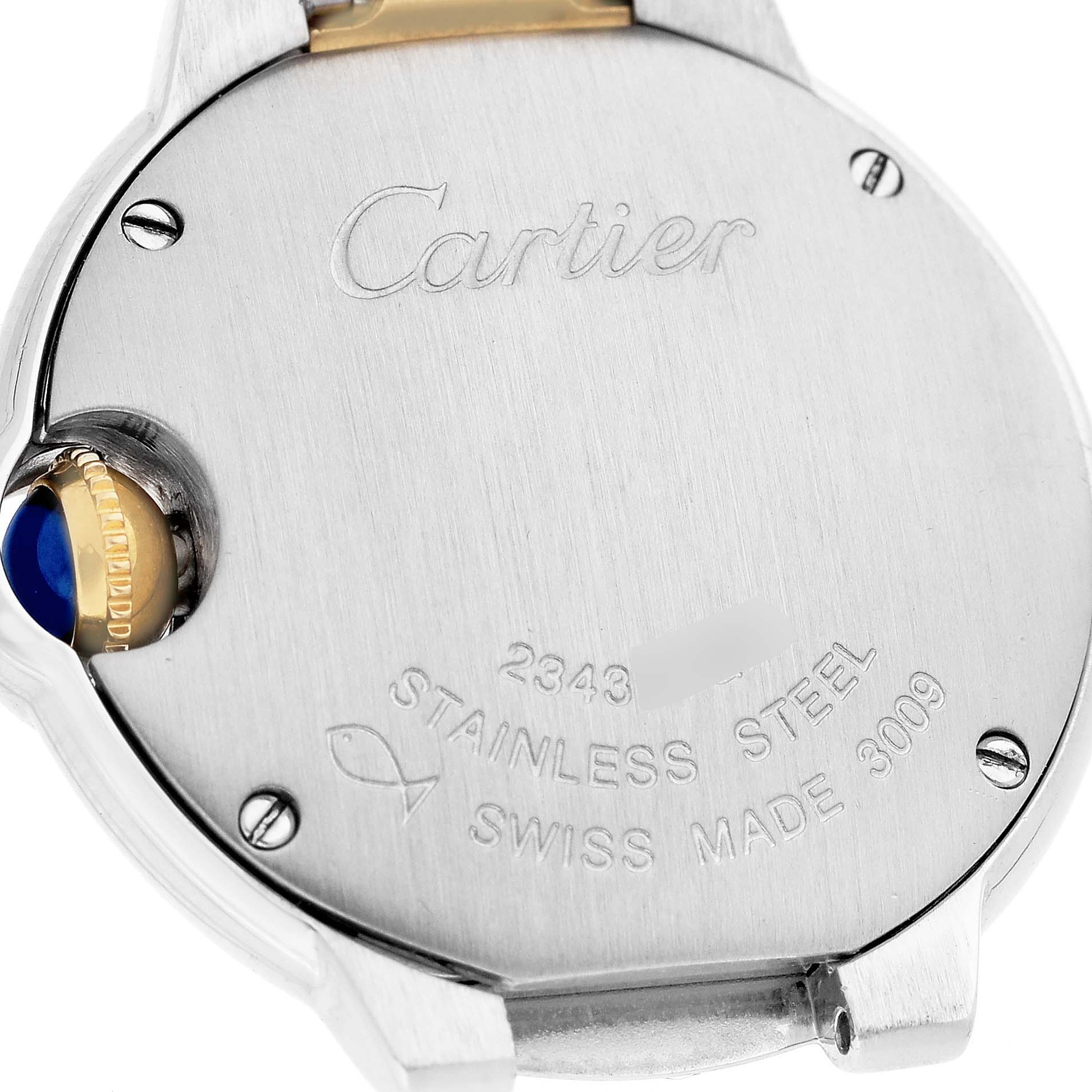 The image shows the back of a Cartier Ballon Bleu W2BB0010 Women
s Steel and Gold (two tone) Silver Dial W2BB0010 Women
s Steel and Gold (two tone) Silver Dial watch with the brand
s engraving and the model details.