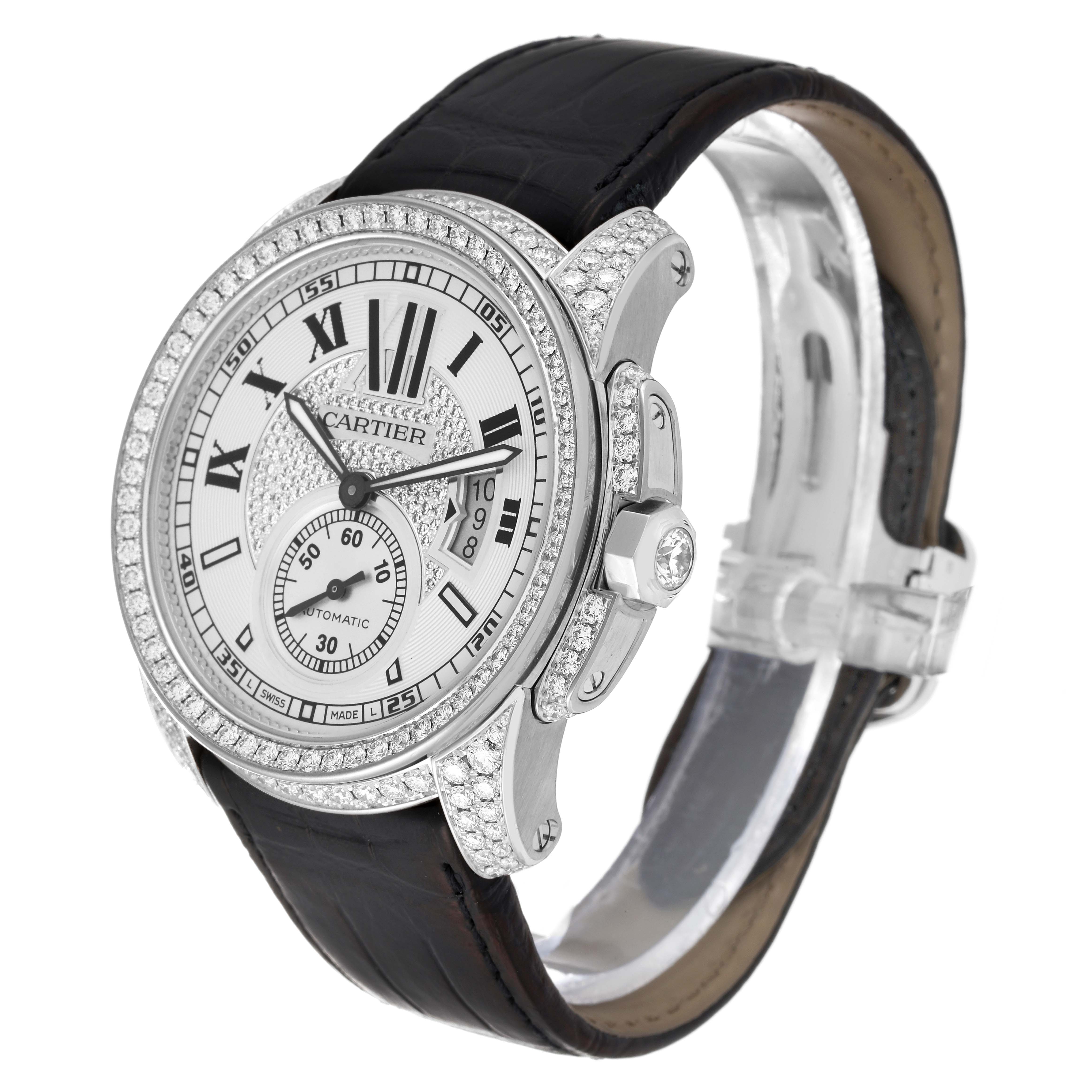 The image shows a front-angle view of a Calibre de Cartier watch by Cartier, featuring its dial, bezel, and leather strap.