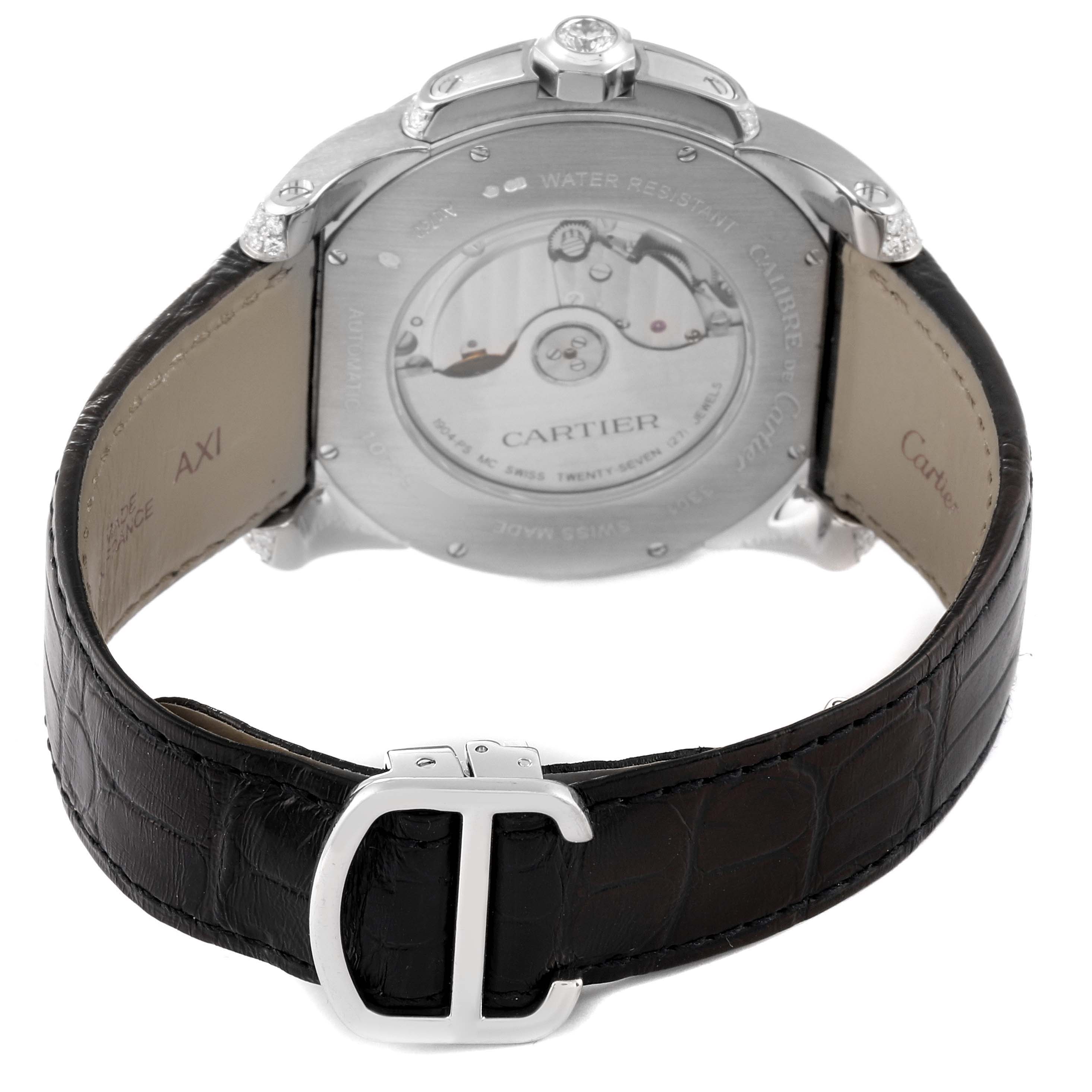 The image shows the back view of a Calibre de Cartier watch by Cartier, featuring the case back and black leather strap.