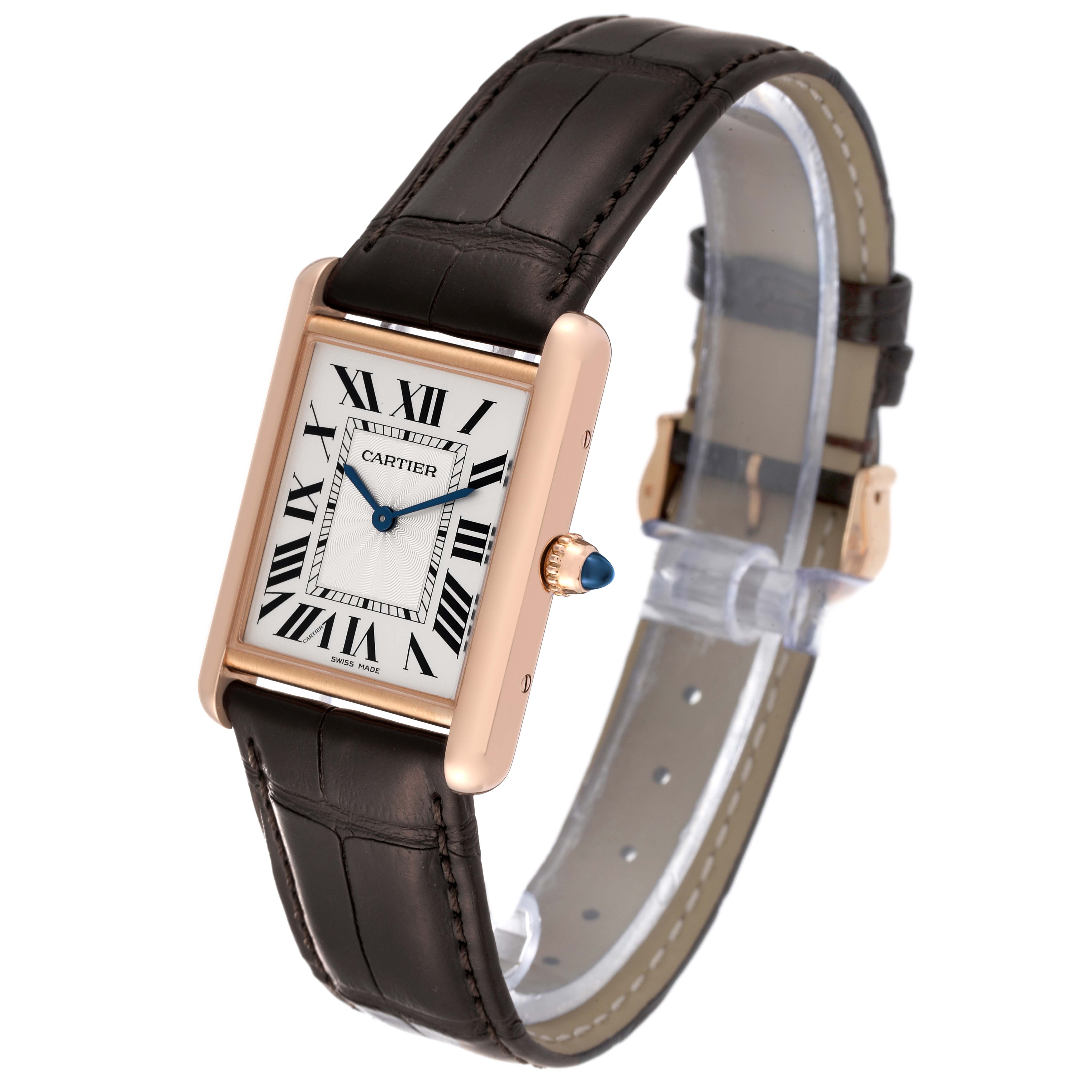 The image shows a Cartier Tank Louis WGTA0011 Men's Rose Gold Silver Dial WGTA0011 Men's Rose Gold Silver Dial watch, highlighting its rectangular face, Roman numeral dial, leather strap, and crown with a blue cabochon.