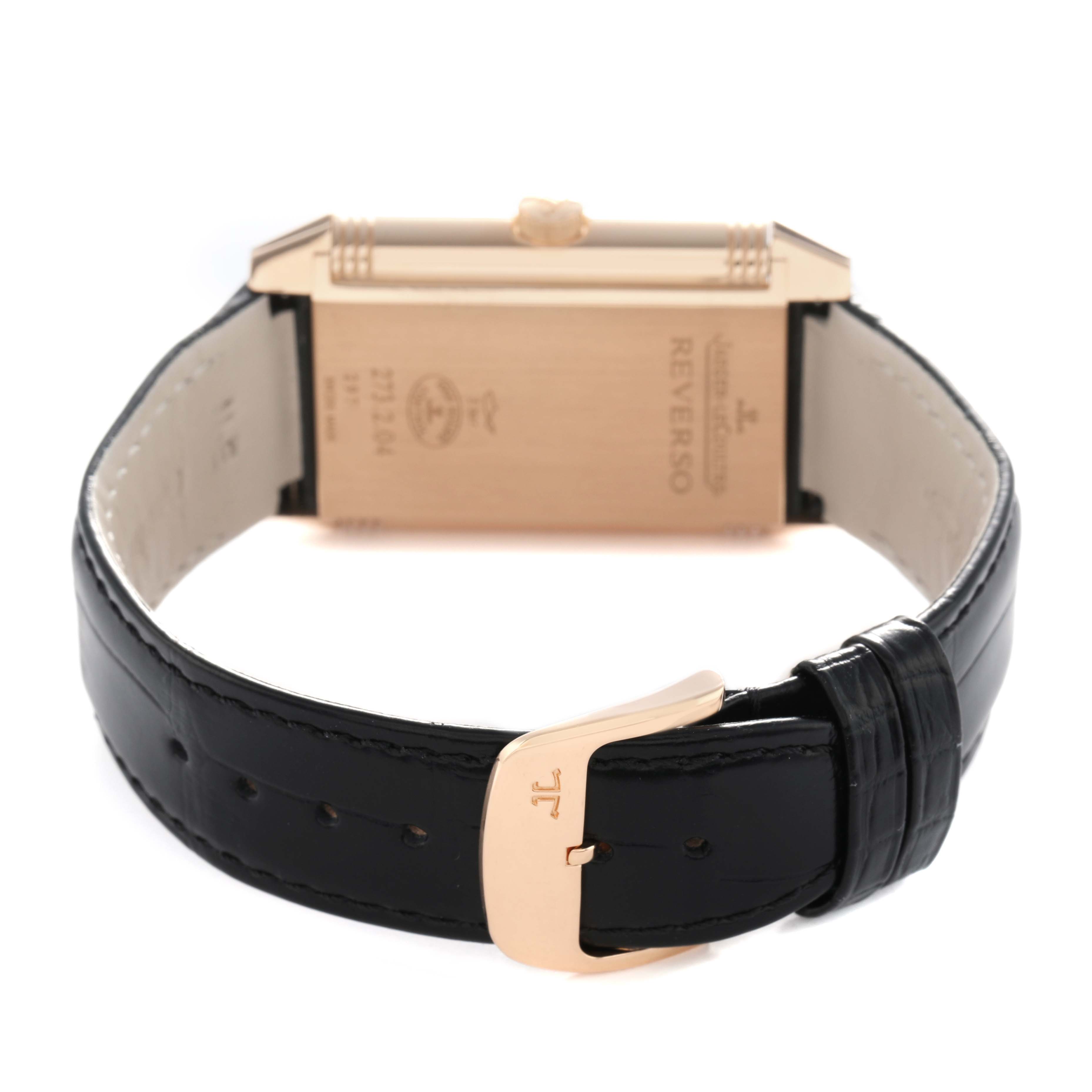 The image shows the back of the Jaeger-LeCoultre Reverso watch, highlighting the leather strap and the rectangular case.