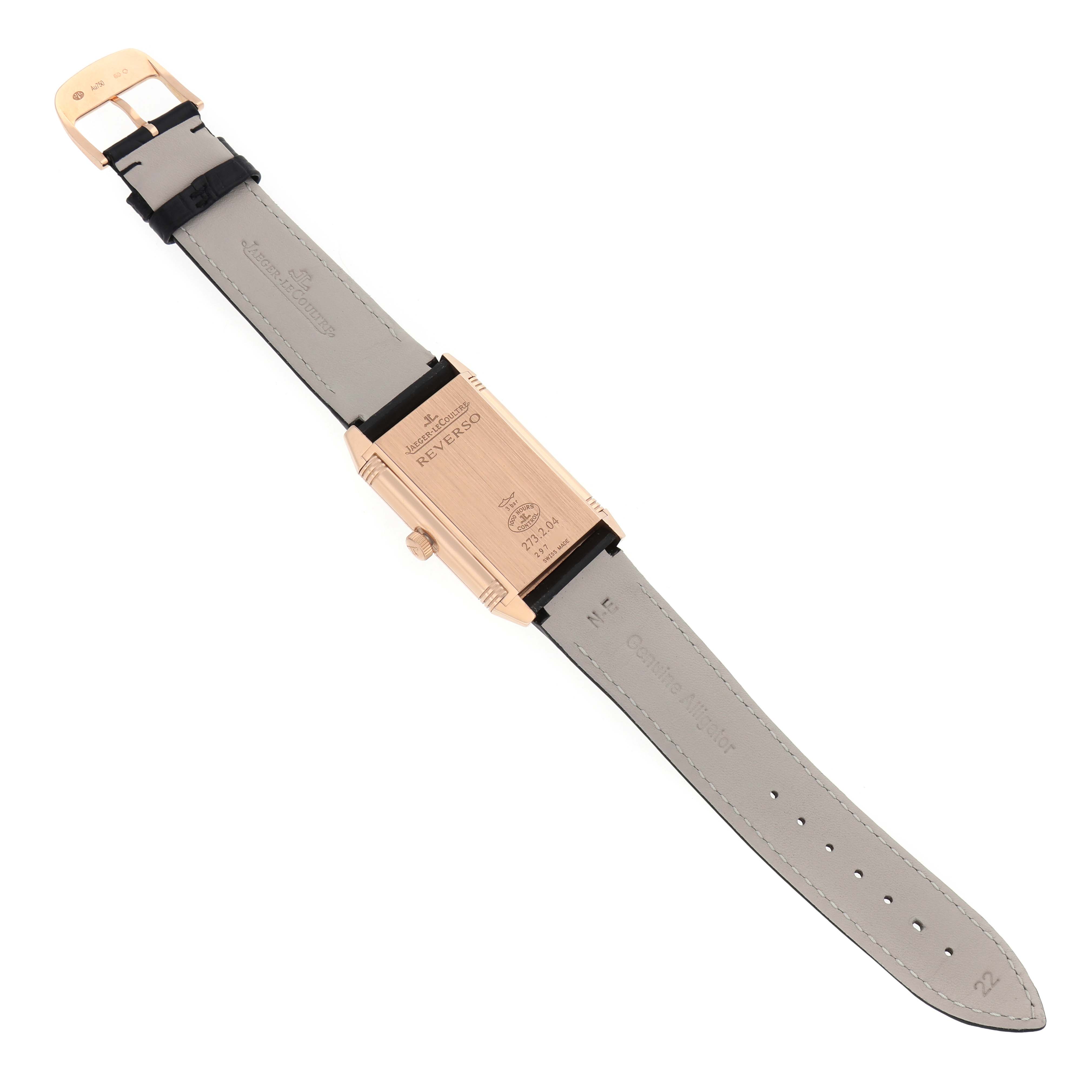 The Jaeger-LeCoultre Reverso watch is shown from the back, highlighting the caseback, crown, and leather strap.