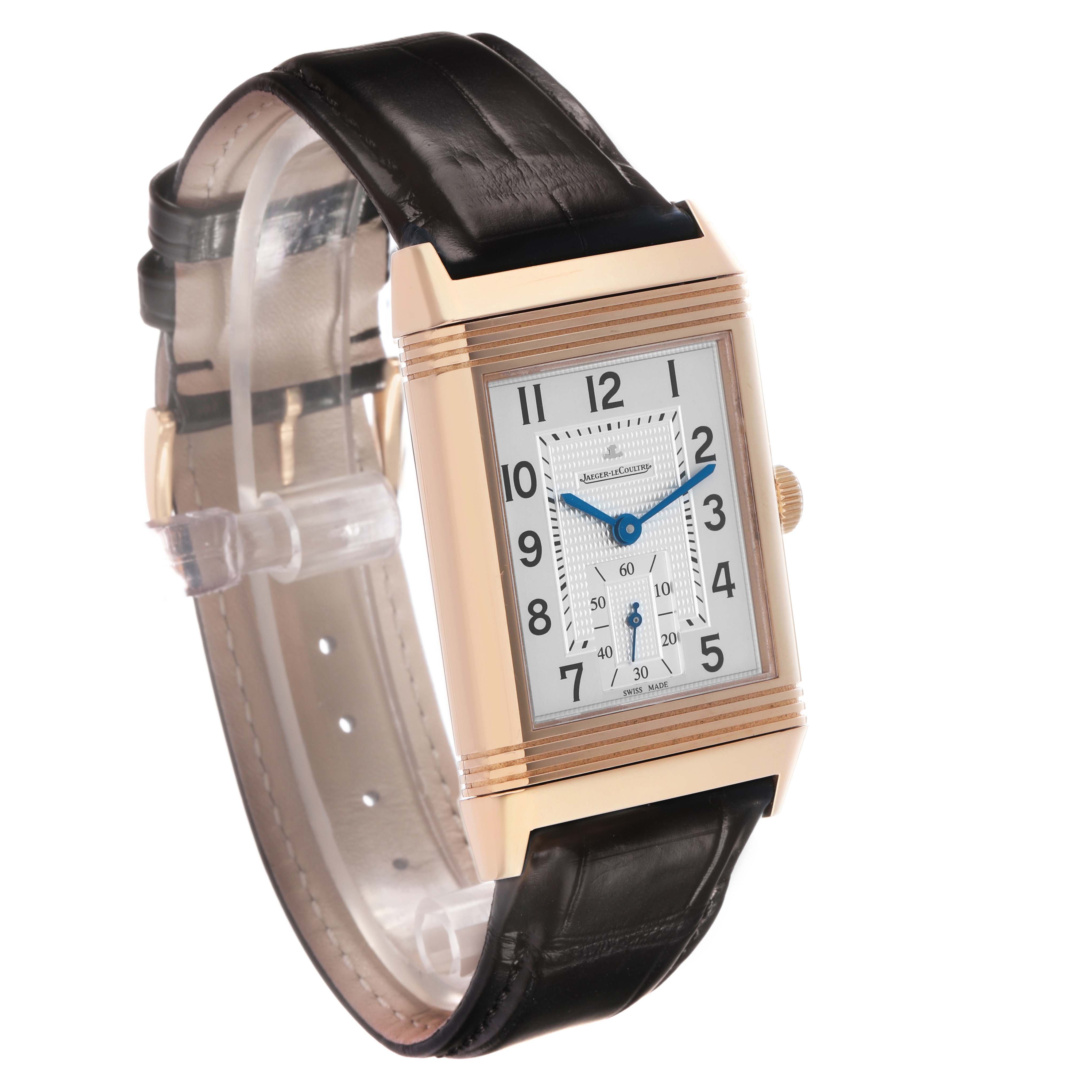 The Jaeger-LeCoultre Reverso watch is shown at a three-quarter angle, displaying the dial, case, crown, and strap.