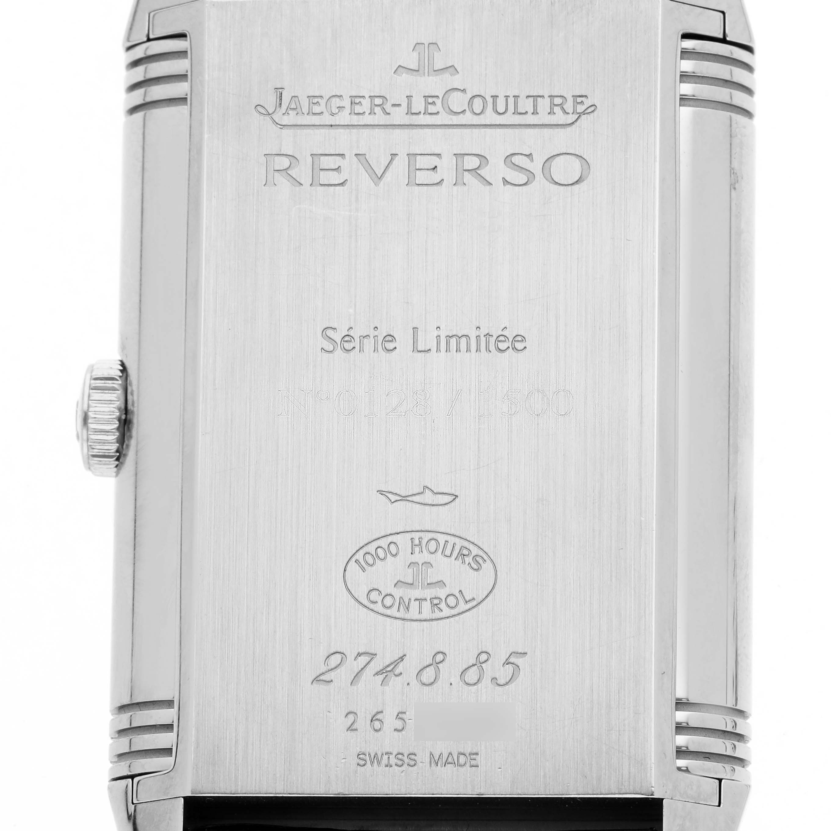 The image shows the back of the Jaeger-LeCoultre Reverso watch, featuring engraving details and the watch crown.