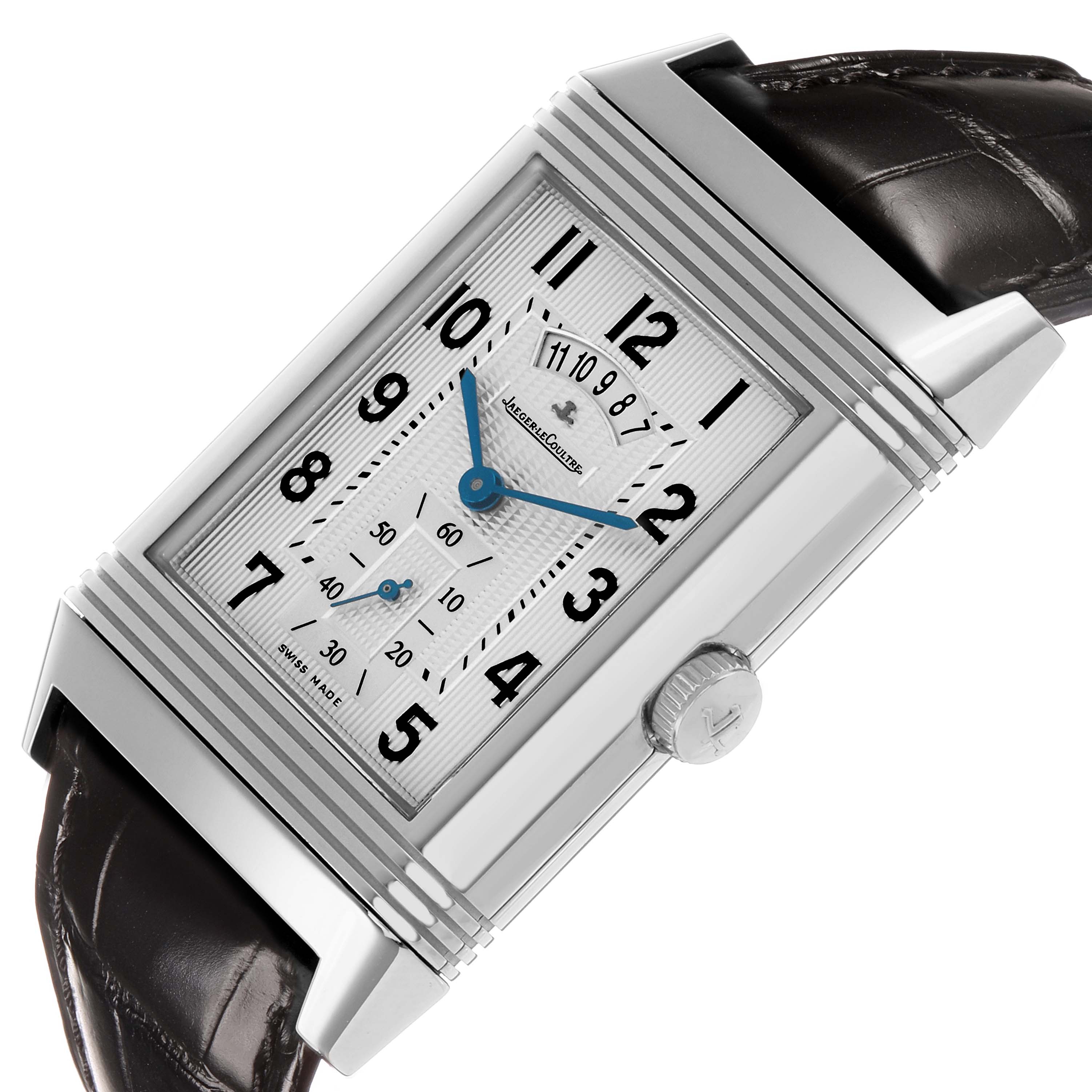 The Jaeger-LeCoultre Reverso watch is shown at a tilted angle, highlighting the dial, case, leather strap, and crown.