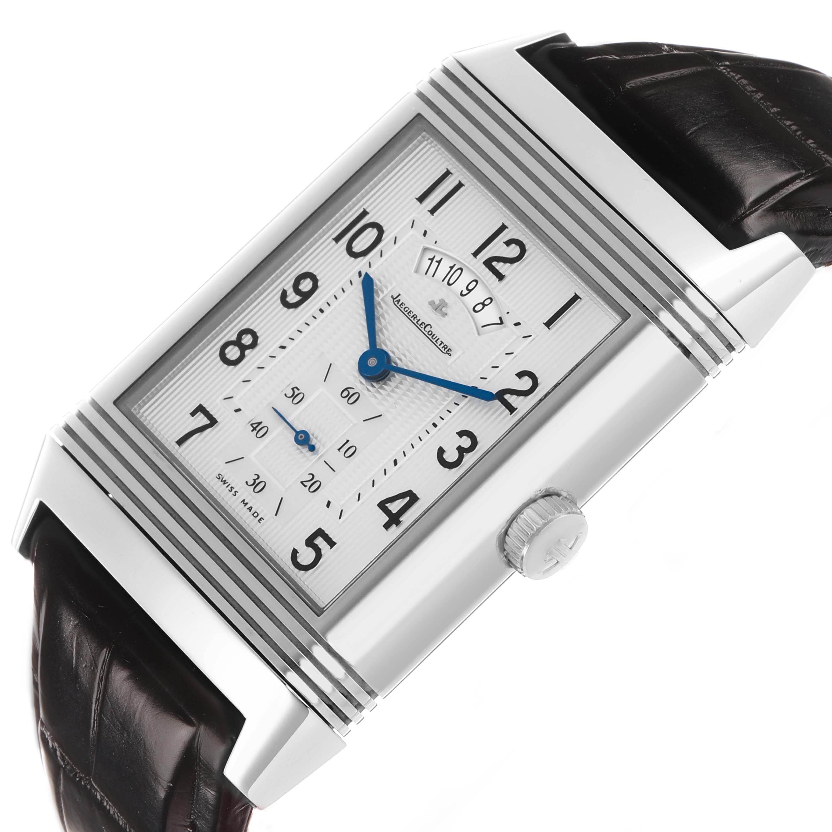 The Jaeger-LeCoultre Reverso watch is shown at an angle highlighting the dial, crown, and leather strap.