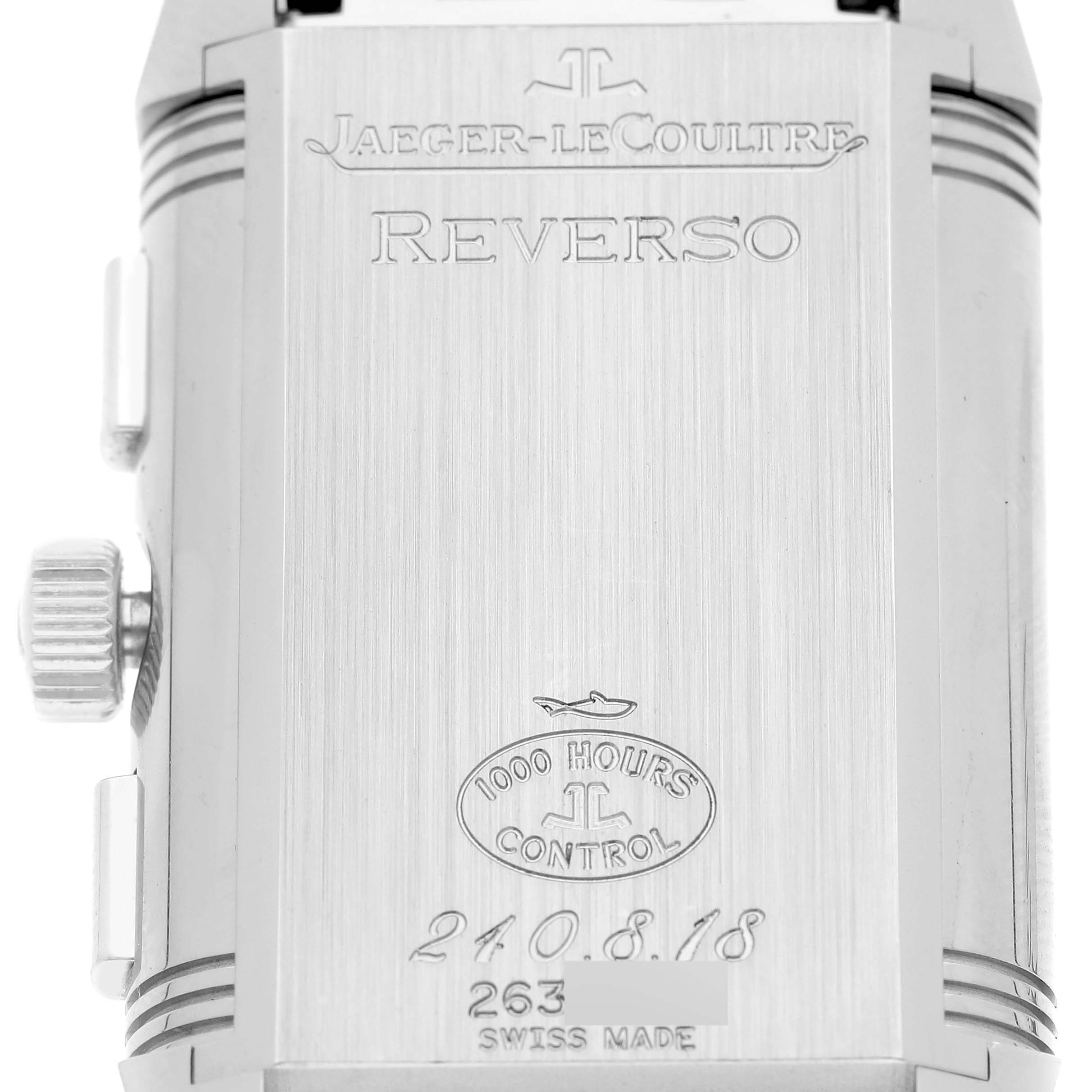 This image shows the back case of a Jaeger-LeCoultre Reverso watch, displaying the brand name, model, certification, and serial number.