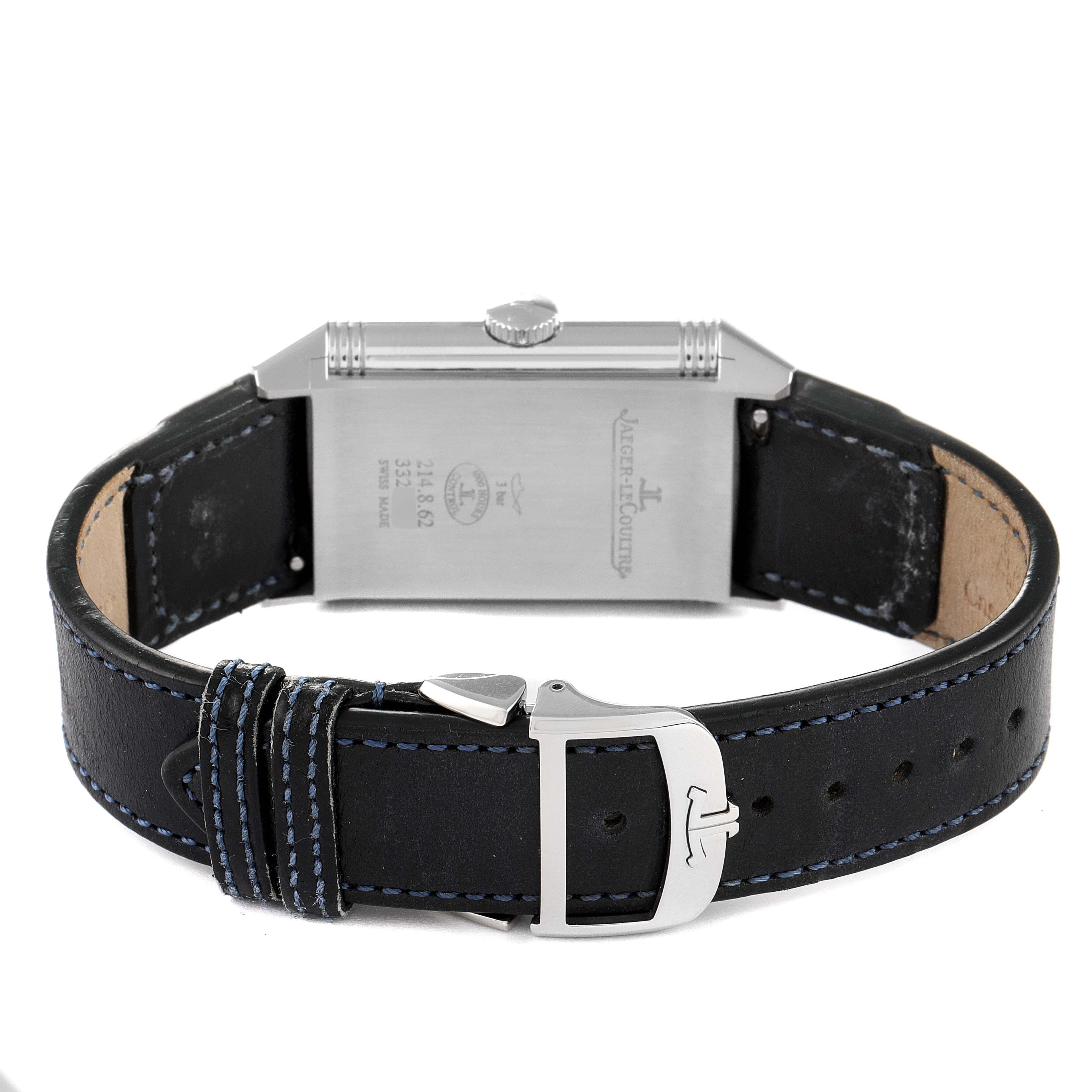 The image shows the back and clasp of a Jaeger-LeCoultre Reverso watch with a black leather strap.