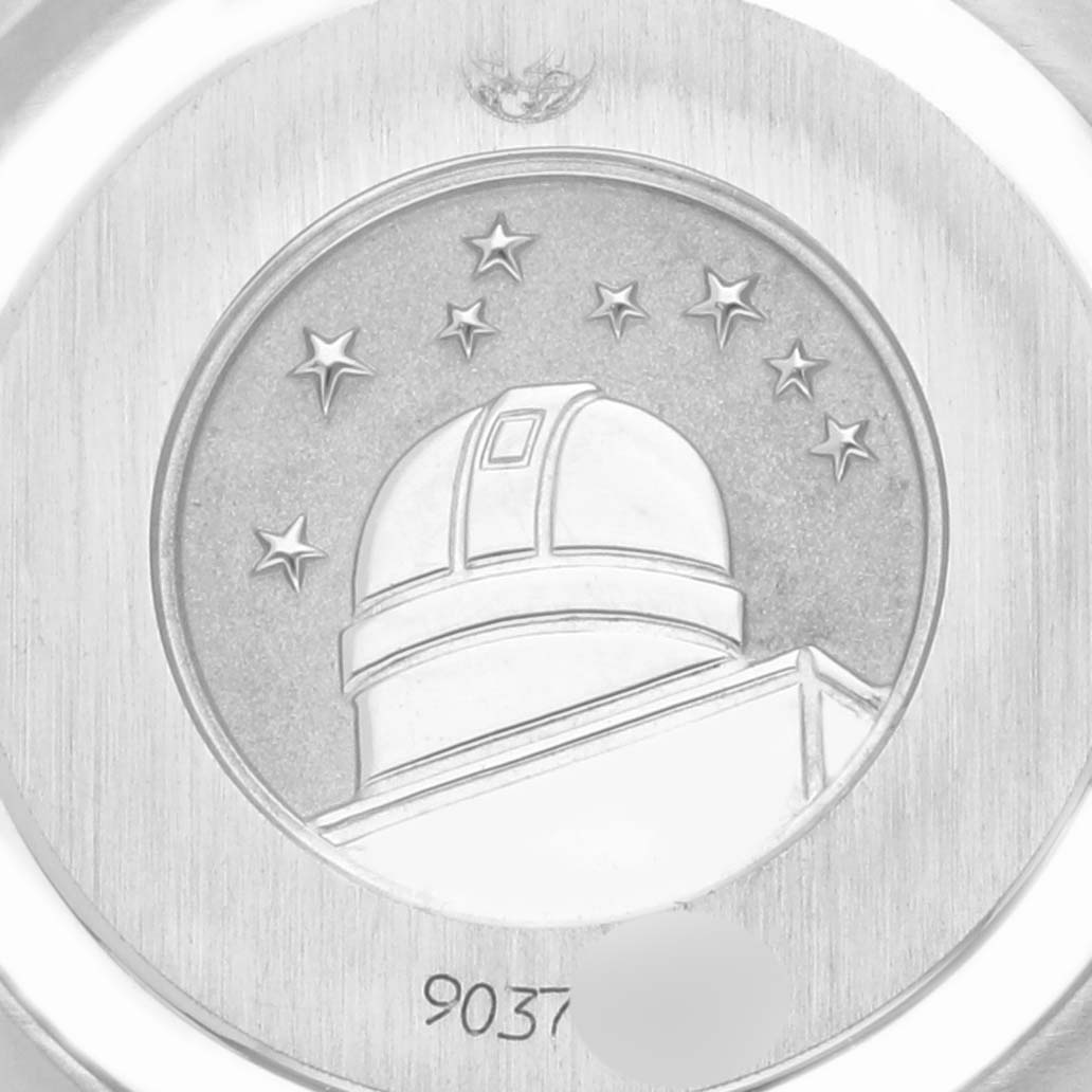 The image shows the case back of the Omega 1267.75.00 Women's Steel and Gold (two tone) Mother of Pearl Dial 1267.75.00 Women's Steel and Gold (two tone) Mother of Pearl Dial Constellation 95 watch featuring an observatory emblem.