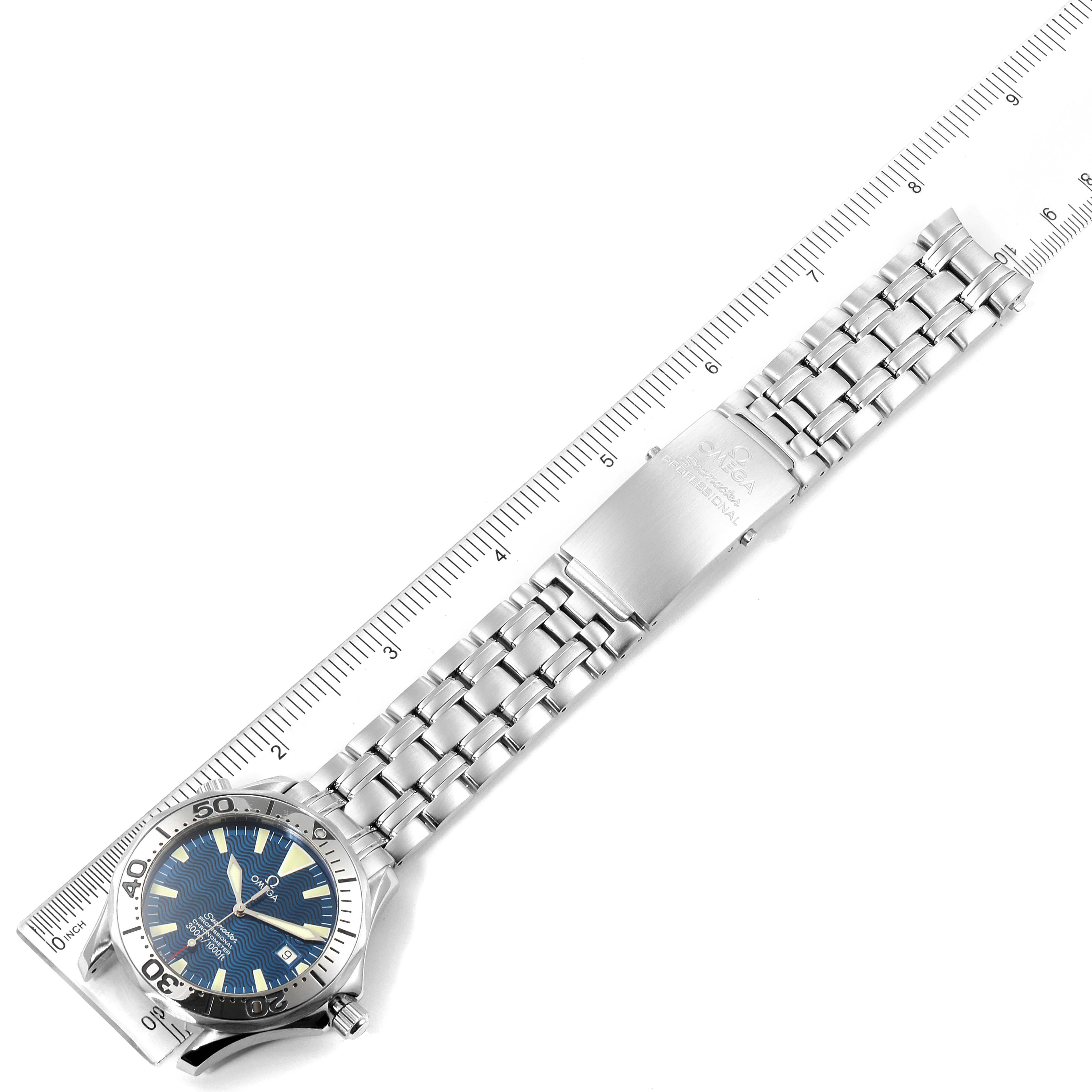 The image shows an Omega Seamaster 2255.80.00 Men
s Stainless Steel Blue Dial 2255.80.00 Men
s Stainless Steel Blue Dial watch laid flat, with a close-up of its bracelet and clasp, alongside a ruler for size reference.