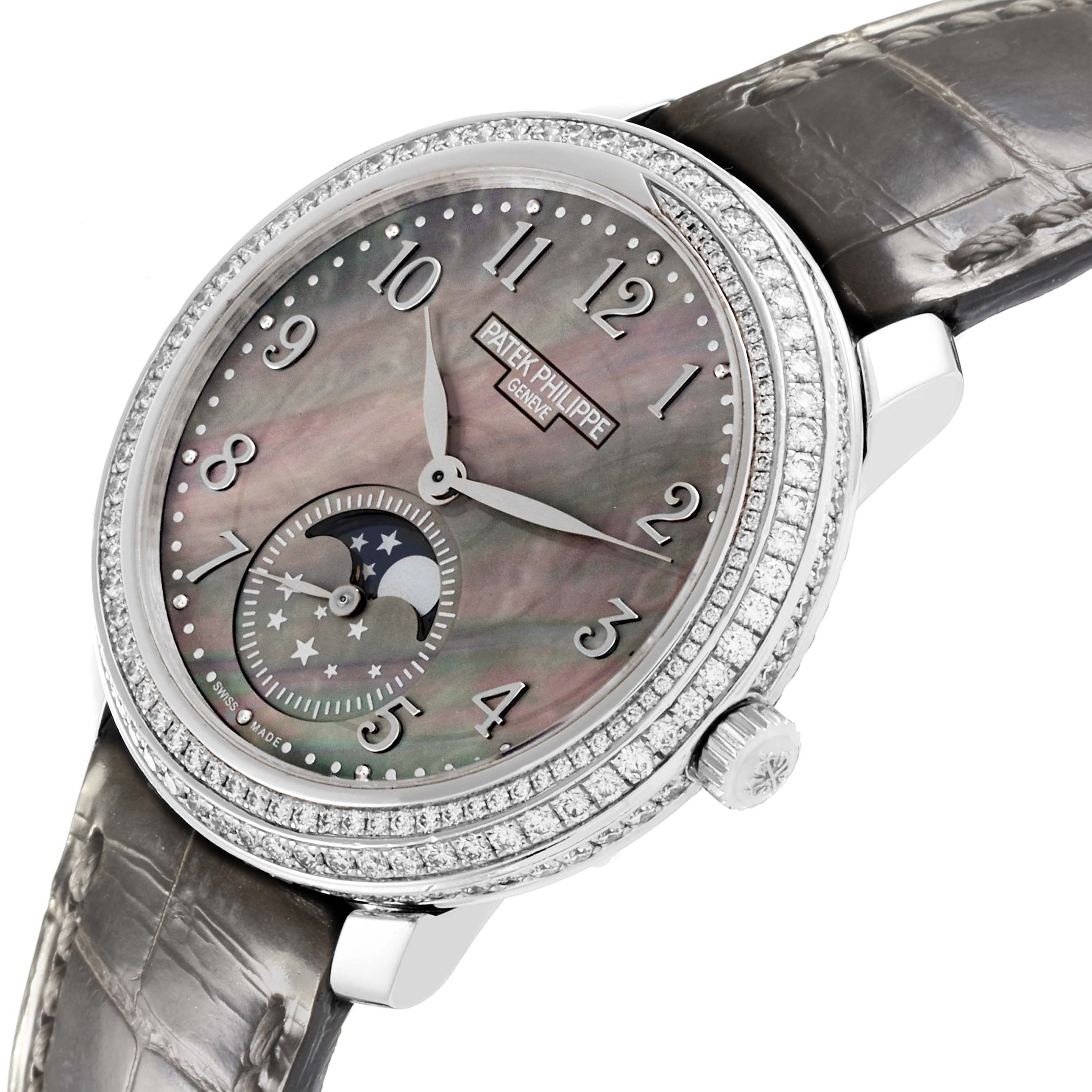 The Patek Philippe Complications 4968G-001 Women's White Gold Mother of Pearl Dial 4968G-001 Women's White Gold Mother of Pearl Dial watch is shown at an angled view, highlighting the mother-of-pearl dial, moon phase, and diamond bezel.