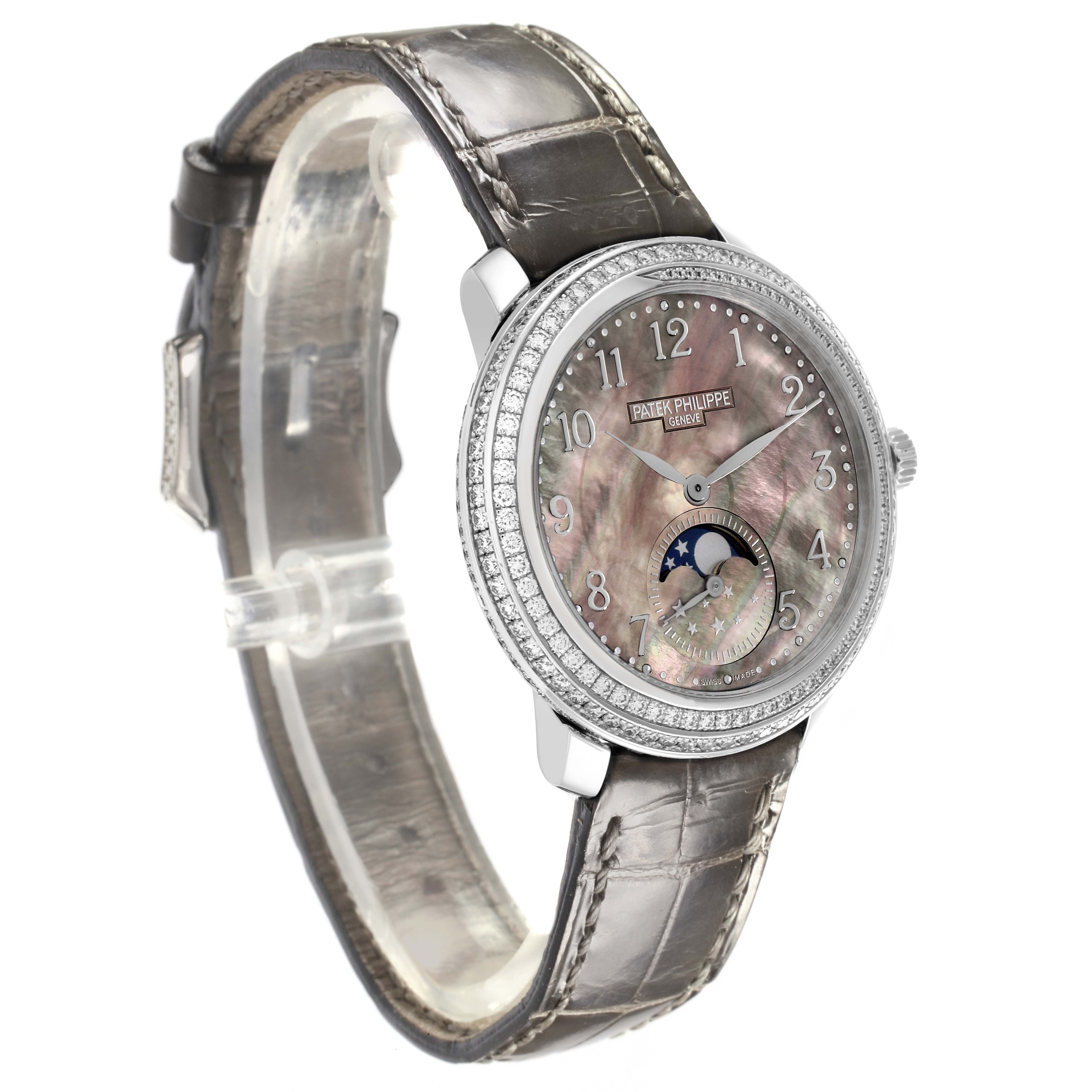 The Patek Philippe Complications 4968G-001 Women's White Gold Mother of Pearl Dial 4968G-001 Women's White Gold Mother of Pearl Dial watch is shown at a three-quarter angle, highlighting its face, bezel, and leather strap.