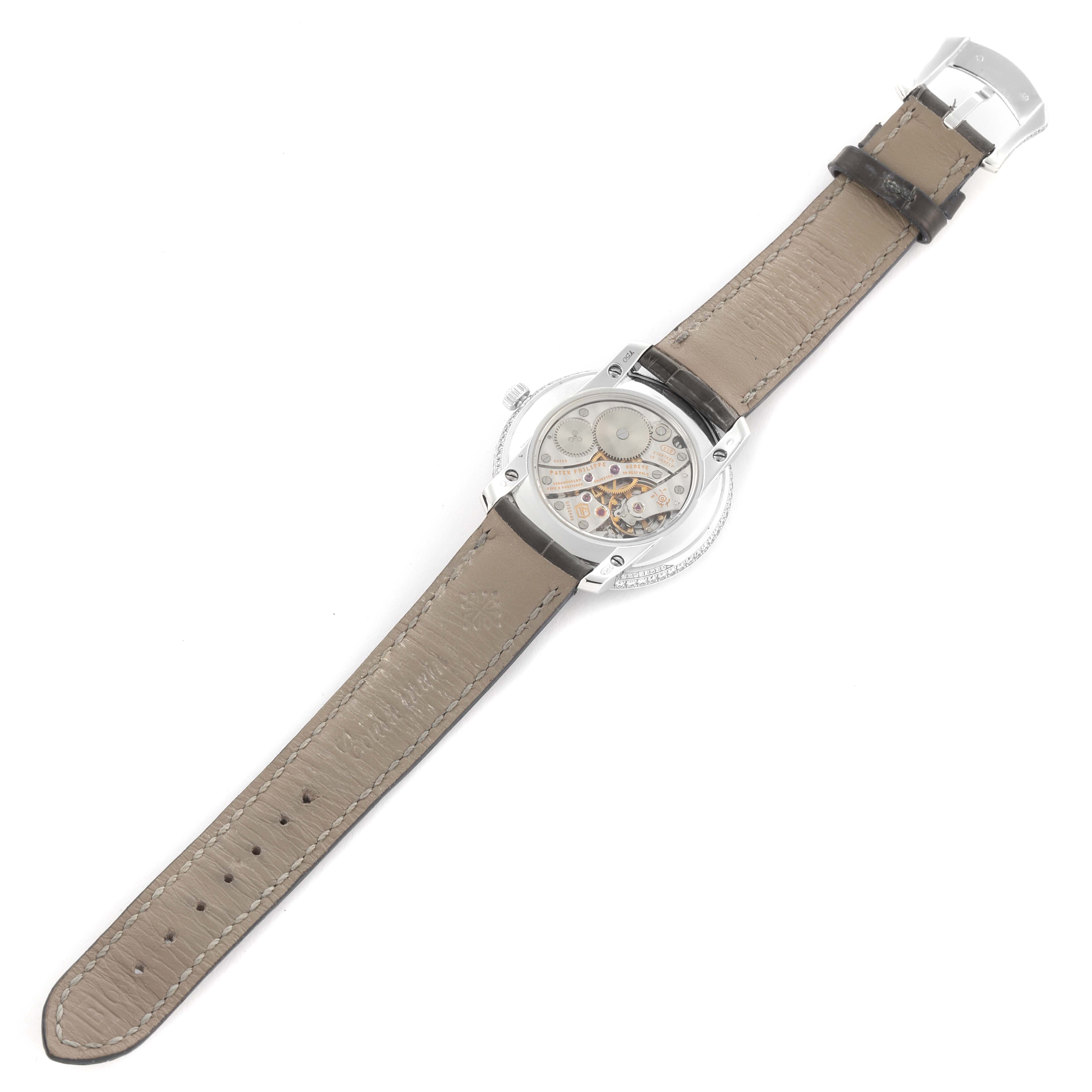 The Patek Philippe Complications 4968G-001 Women's White Gold Mother of Pearl Dial 4968G-001 Women's White Gold Mother of Pearl Dial watch is shown from the back, displaying the movement and the leather strap.