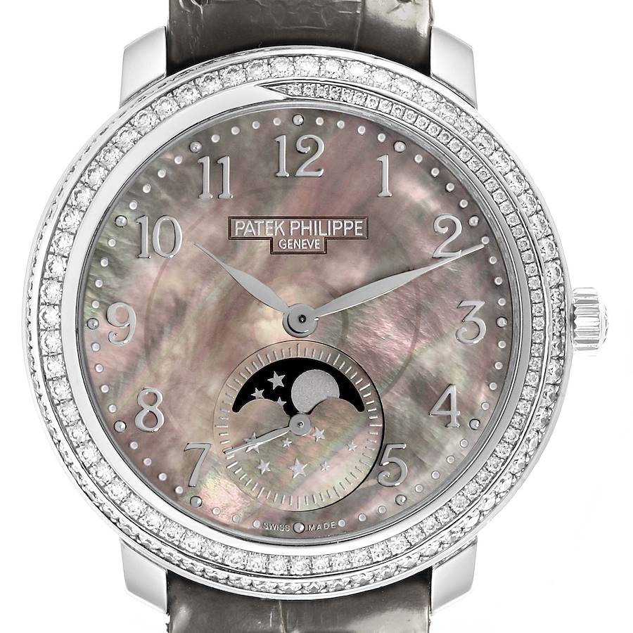 The Patek Philippe Complications watch is shown from the front, featuring the dial, bezel, and part of the strap.