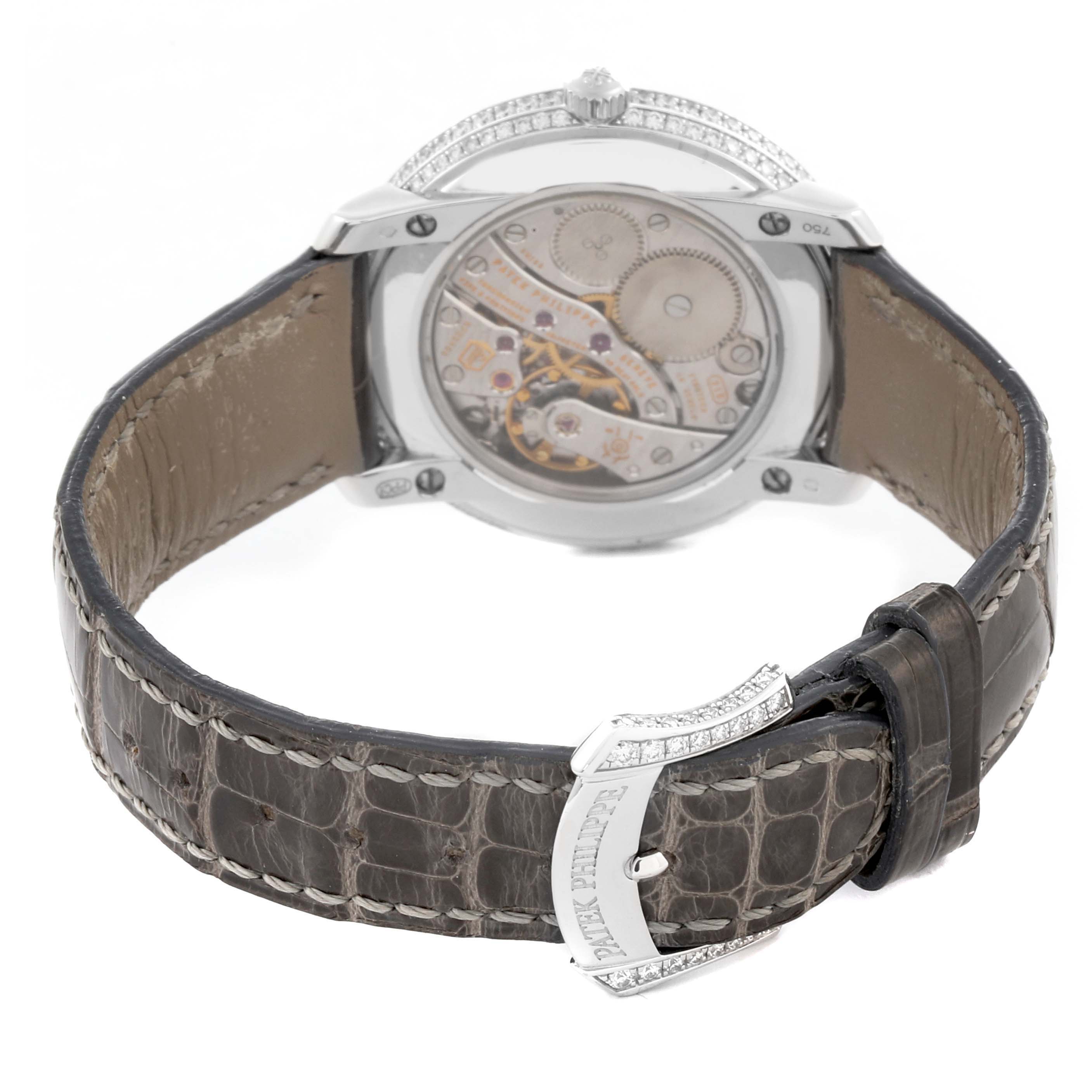The Patek Philippe Complications 4968G-001 Women's White Gold Mother of Pearl Dial 4968G-001 Women's White Gold Mother of Pearl Dial watch is shown from the back, highlighting the movement and leather strap with a jeweled buckle.