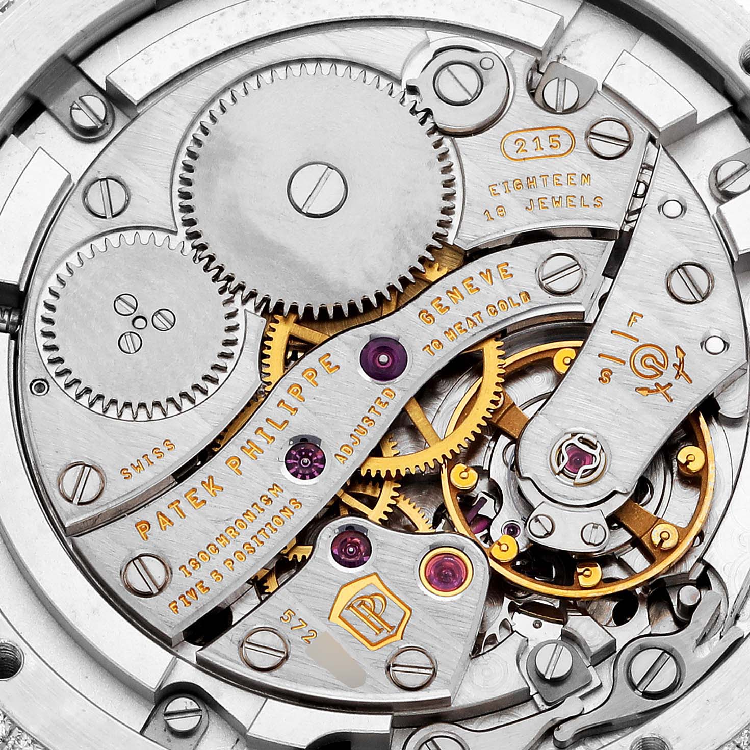 The image shows the intricate inner gears and components of the Patek Philippe Complications 4968G-001 Women's White Gold Mother of Pearl Dial 4968G-001 Women's White Gold Mother of Pearl Dial watch from a close-up, top-down angle.