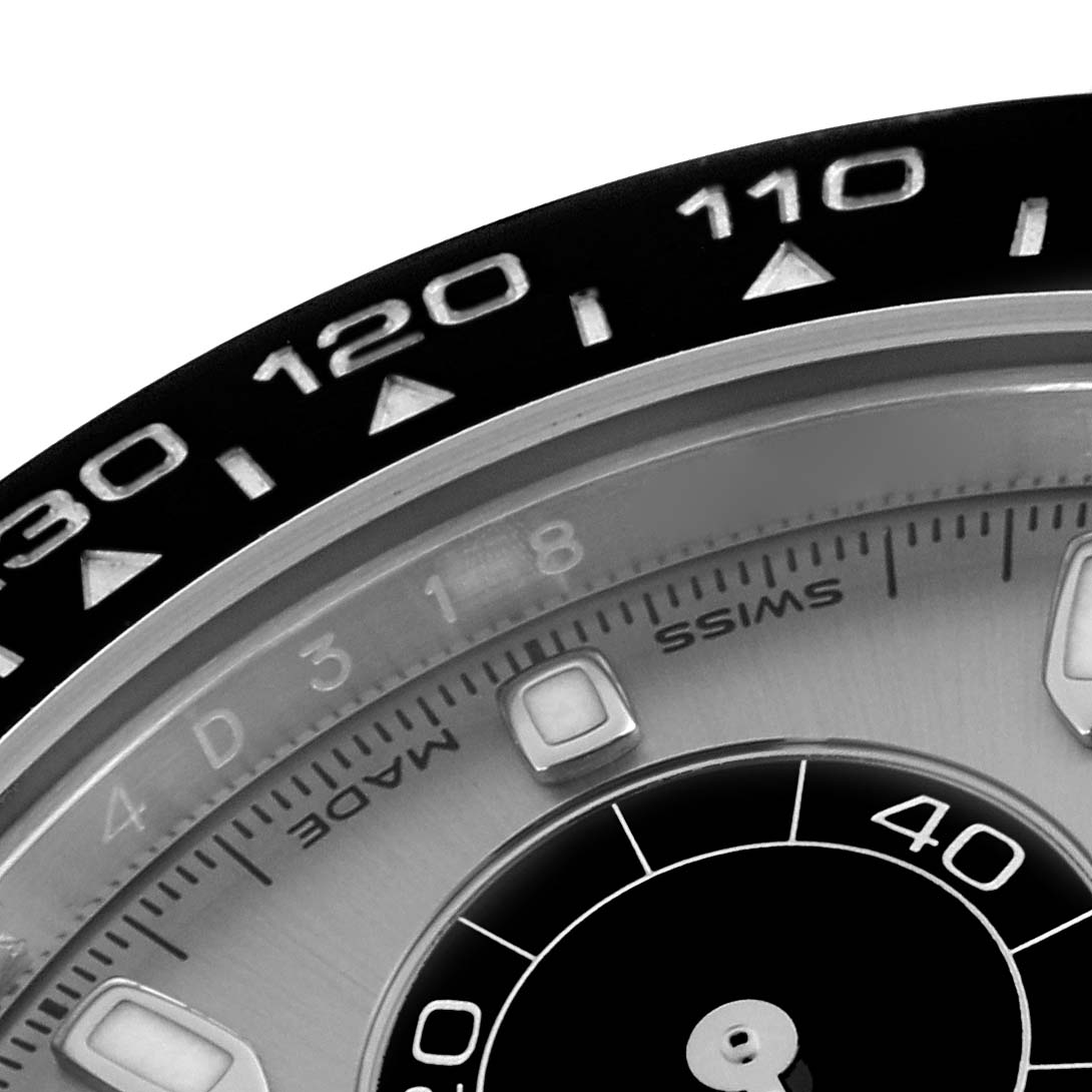 This image shows a close-up of the Rolex Daytona 116519LN Men's White Gold Grey Dial 116519LN Men's White Gold Grey Dial's bezel and part of the dial, detailing the tachymeter scale and hour markers.