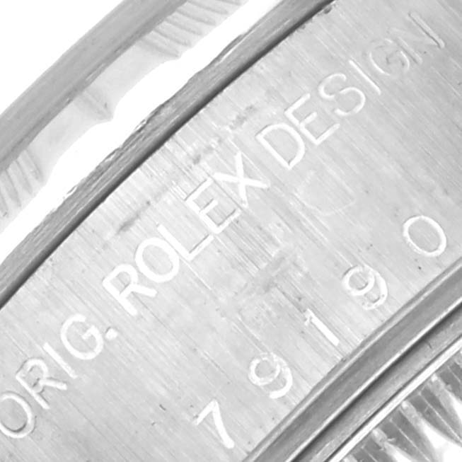 The image shows a close-up of the side engraving on a Rolex Date 79190 Women's Stainless Steel Blue Dial 79190 Women's Stainless Steel Blue Dial model, highlighting "ROLEX DESIGN" and serial numbers.