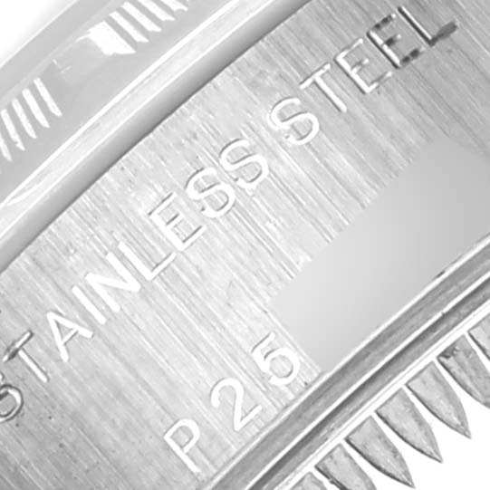 The image shows a close-up of the Rolex Date 79190 Women's Stainless Steel Blue Dial 79190 Women's Stainless Steel Blue Dial model case back, highlighting "STAINLESS STEEL" and part of the serial number.