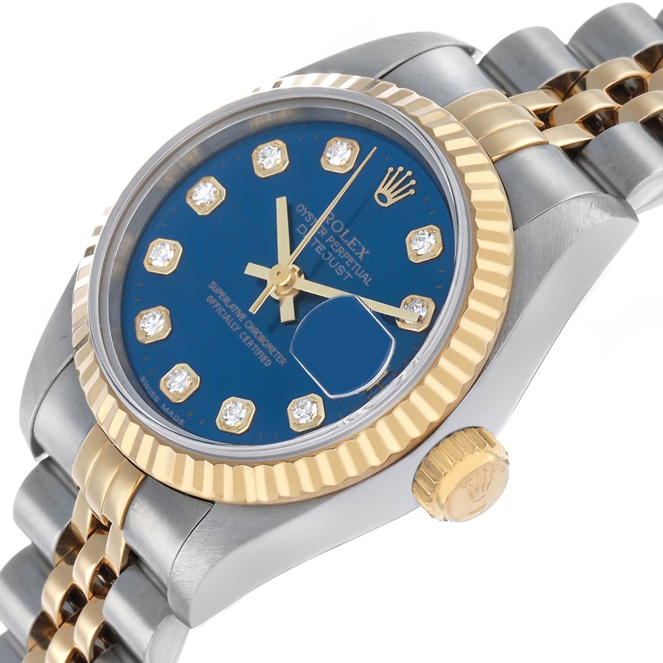 The Rolex Datejust 69173 Women's Steel and Gold (two tone) Blue Dial watch is shown at an angle highlighting the blue dial, diamond hour markers, and gold and silver bracelet.