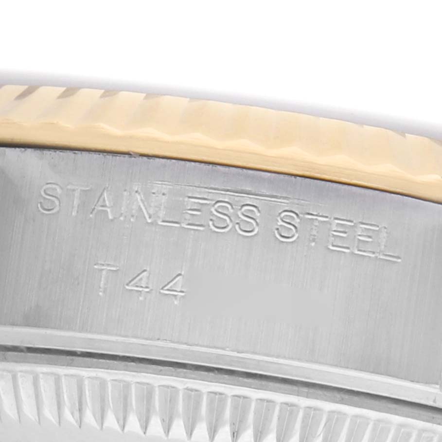 The image shows a close-up of the side of a Rolex Datejust 69173 Women's Steel and Gold (two tone) Blue Dial watch, focusing on the stainless steel engraved section.