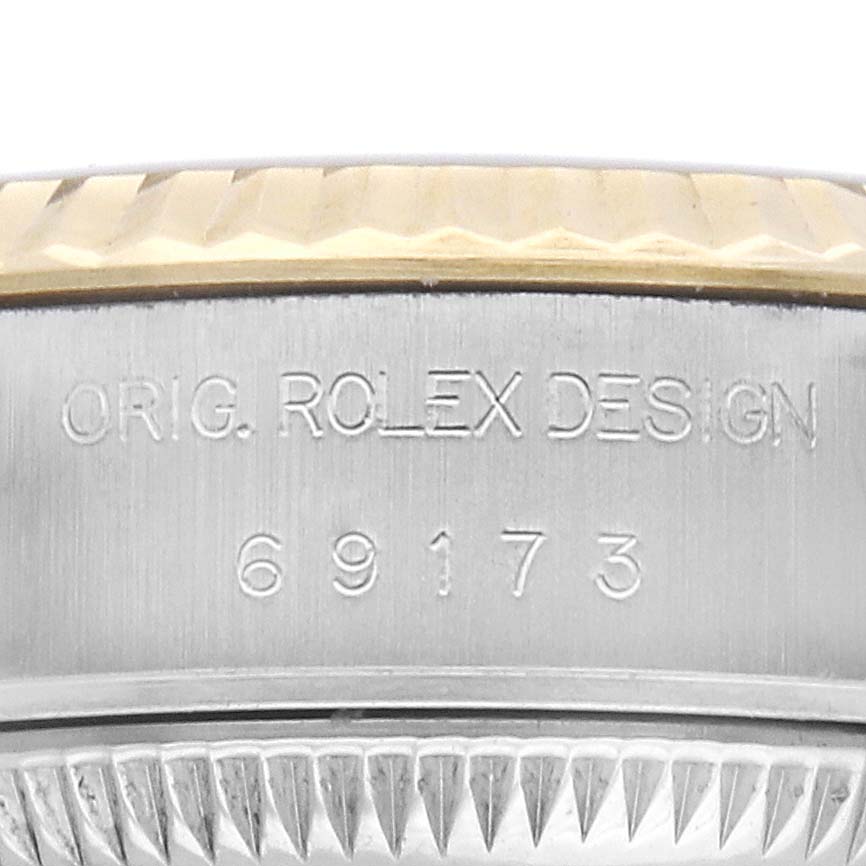 The image shows a close-up of the side of a Rolex Datejust 69173 Men's Steel and Gold (two tone) Champagne Dial, revealing the model number engraving and part of the bezel.