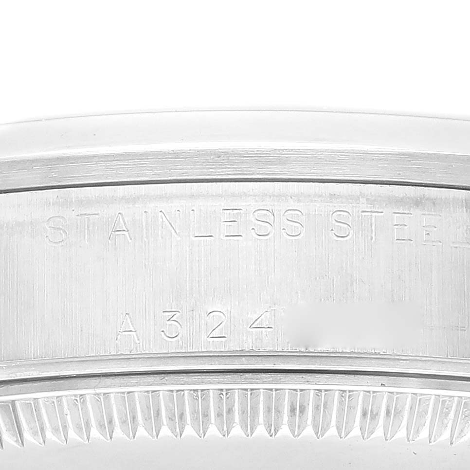 The image shows a close-up of the case back edge with "Stainless Steel" engraving on a Rolex Mid-Size 78240 Women
s Stainless Steel Blue Dial 78240 Women
s Stainless Steel Blue Dial watch.