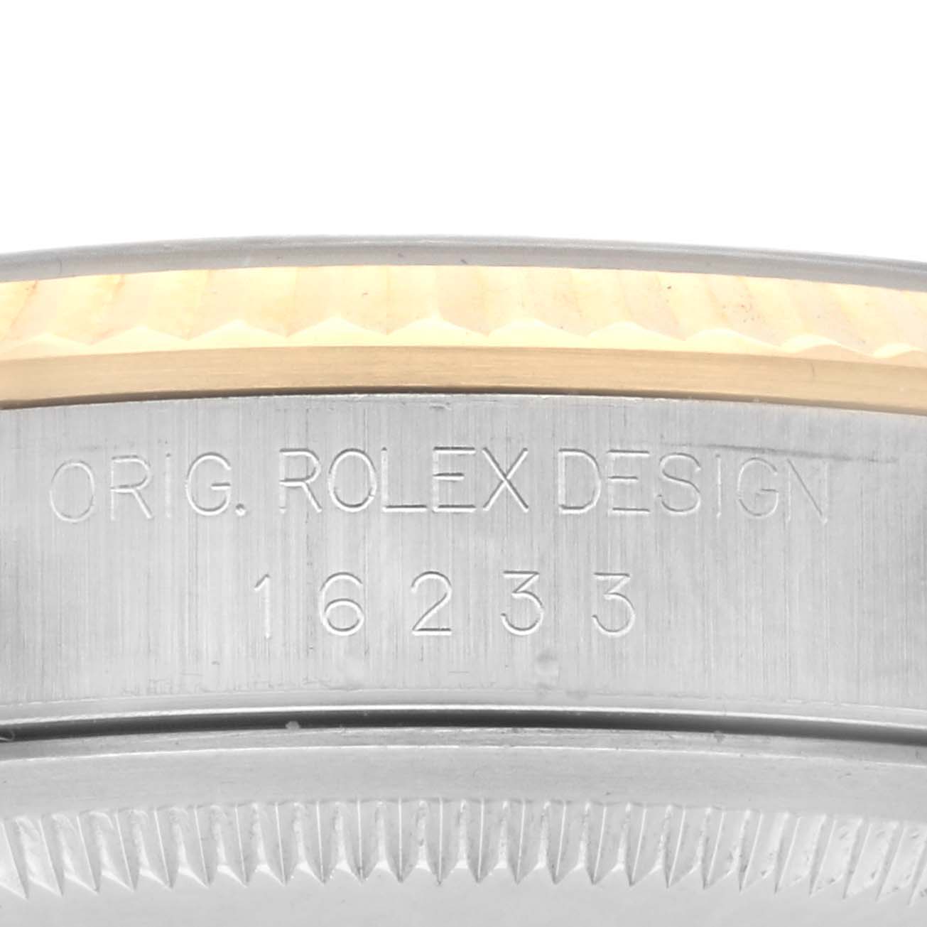 The image shows a close-up of the side of a Rolex Datejust 16233 Men's Steel and Gold (two tone) Black Dial 16233 Men's Steel and Gold (two tone) Black Dial, highlighting the engraved model number "16233" and design text.