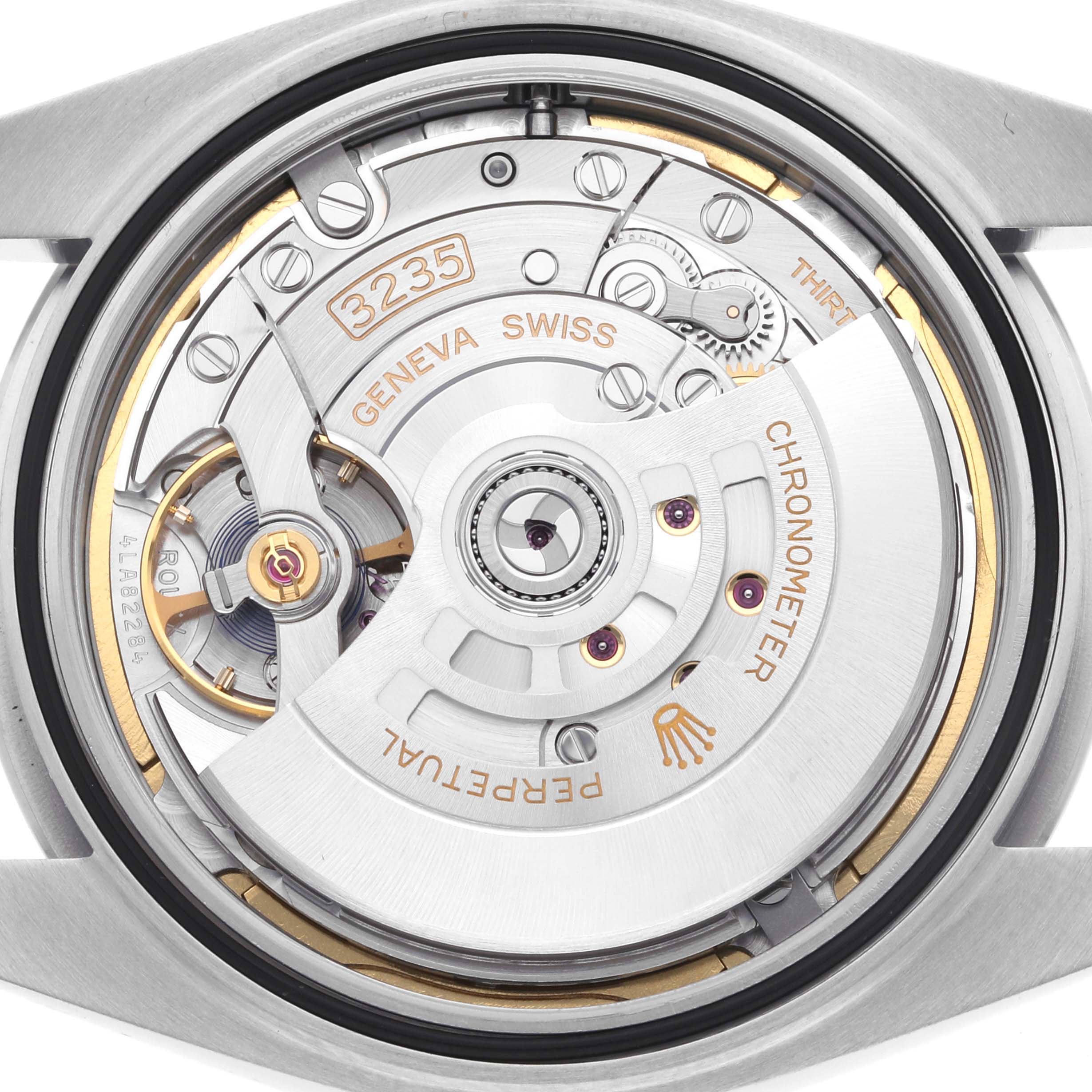 The image shows the movement from the back of a Rolex Datejust 41 126300 Men's Stainless Steel Grey Dial 126300 Men's Stainless Steel Grey Dial, highlighting its intricate mechanism and engravings.