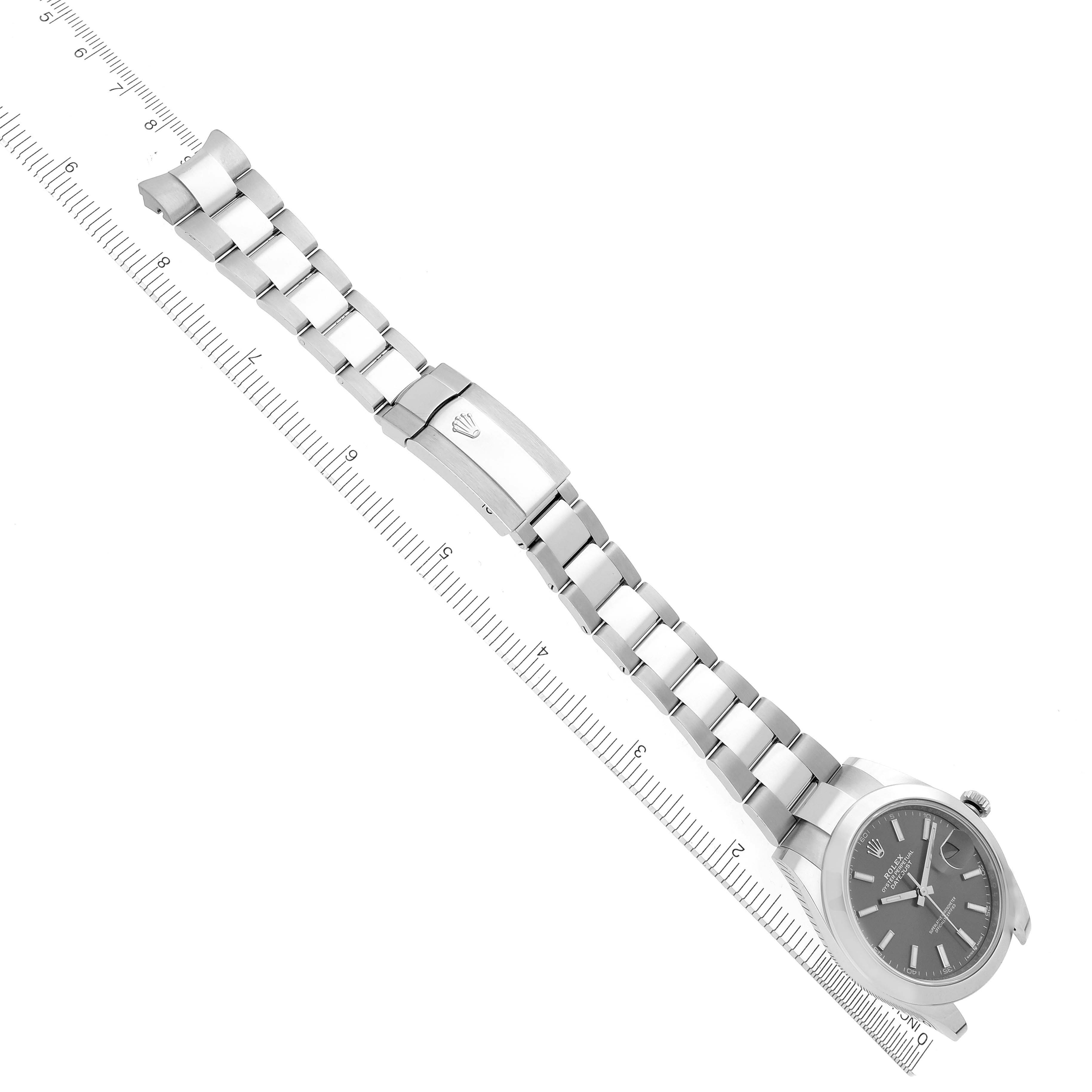 The Rolex Datejust 41 126300 Men's Stainless Steel Grey Dial 126300 Men's Stainless Steel Grey Dial is shown from a high angle, displaying its bracelet, clasp, and face alongside a ruler for scale.