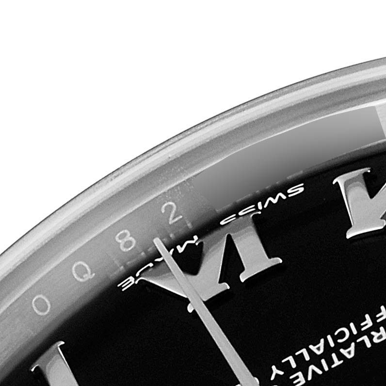 This image shows a close-up angled view of the dial, bezel, and part of the numeral markers of a Mid-Size Rolex watch.